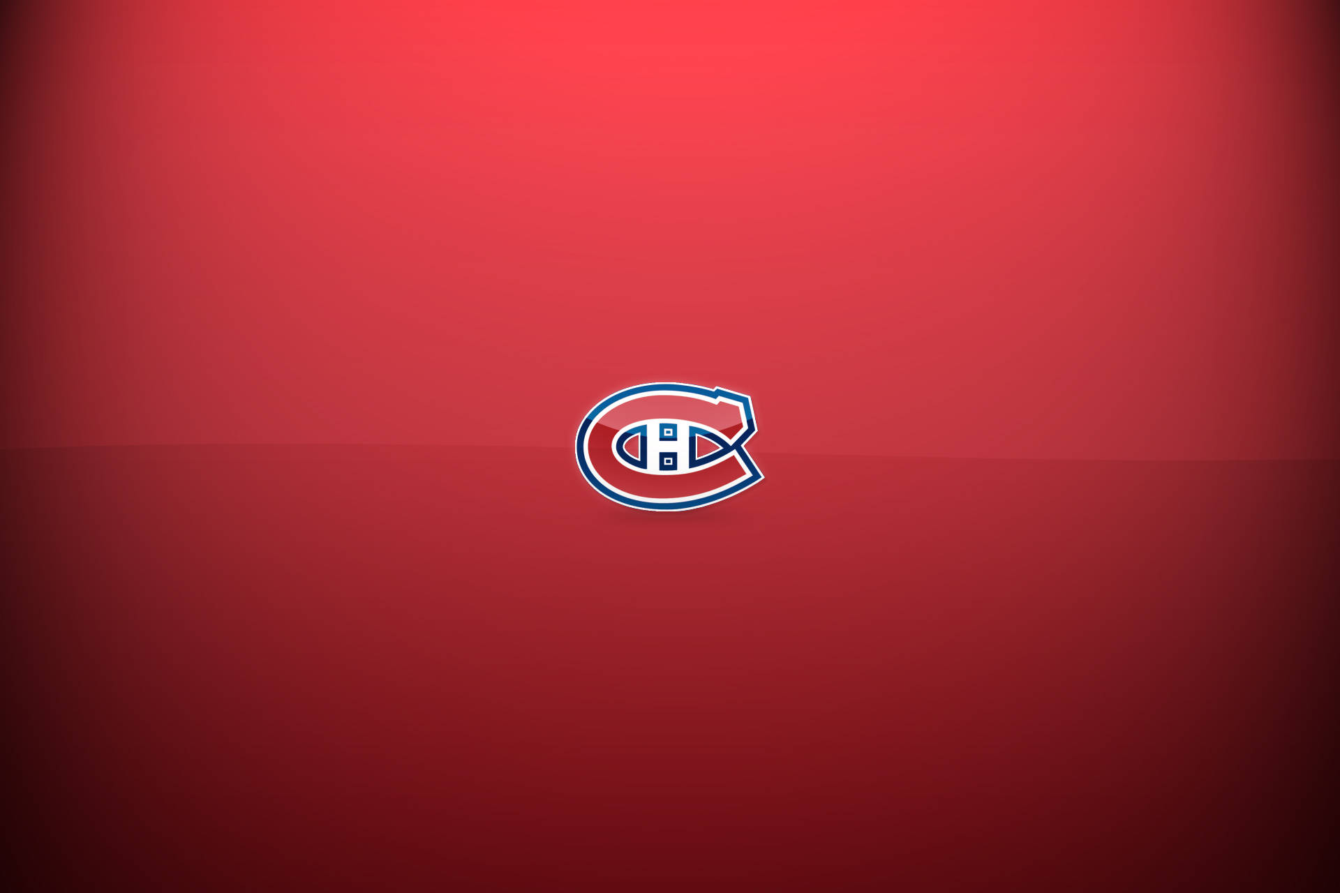 Canadiens 桌布 壁紙 — 蒙特婁加拿大人隊標誌居中於漸變紅色背景上，帶有微妙的燈光效果。