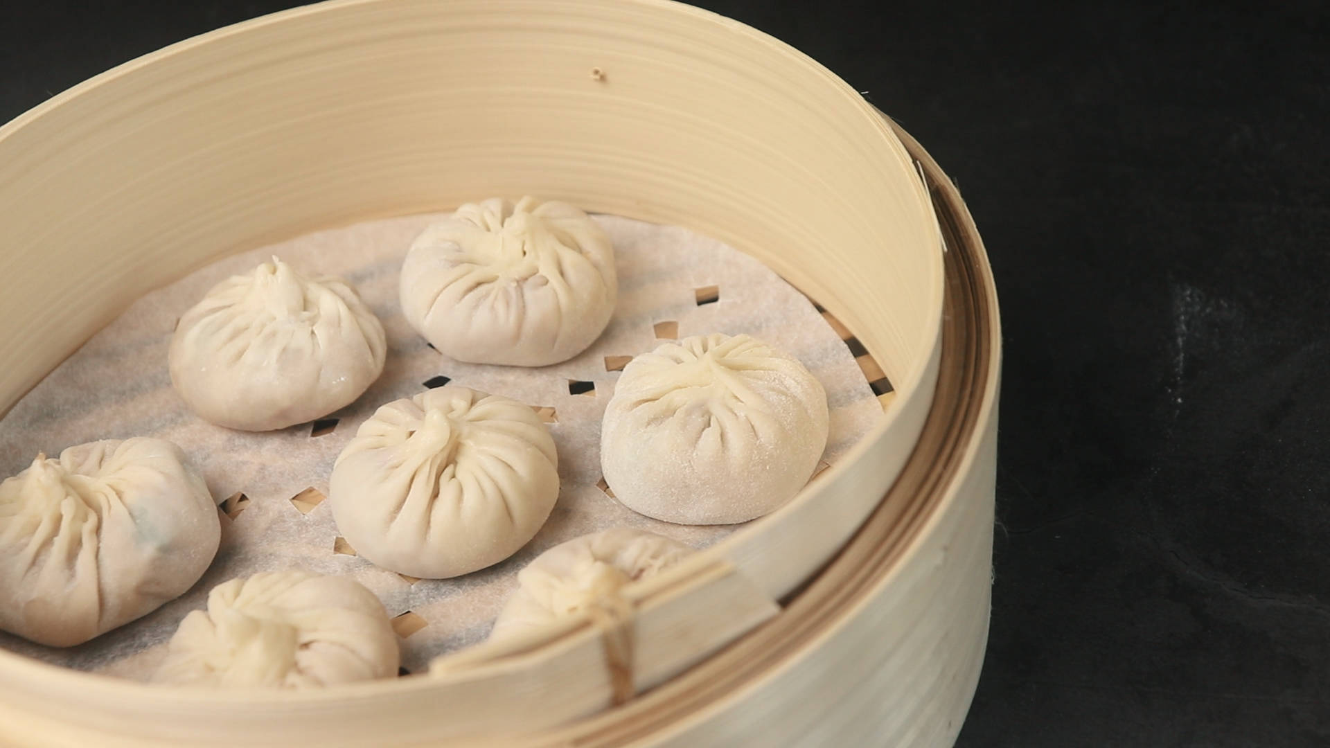 steam 桌布 壁紙 — 蒸餃放在竹蒸籠裡，背景深色。