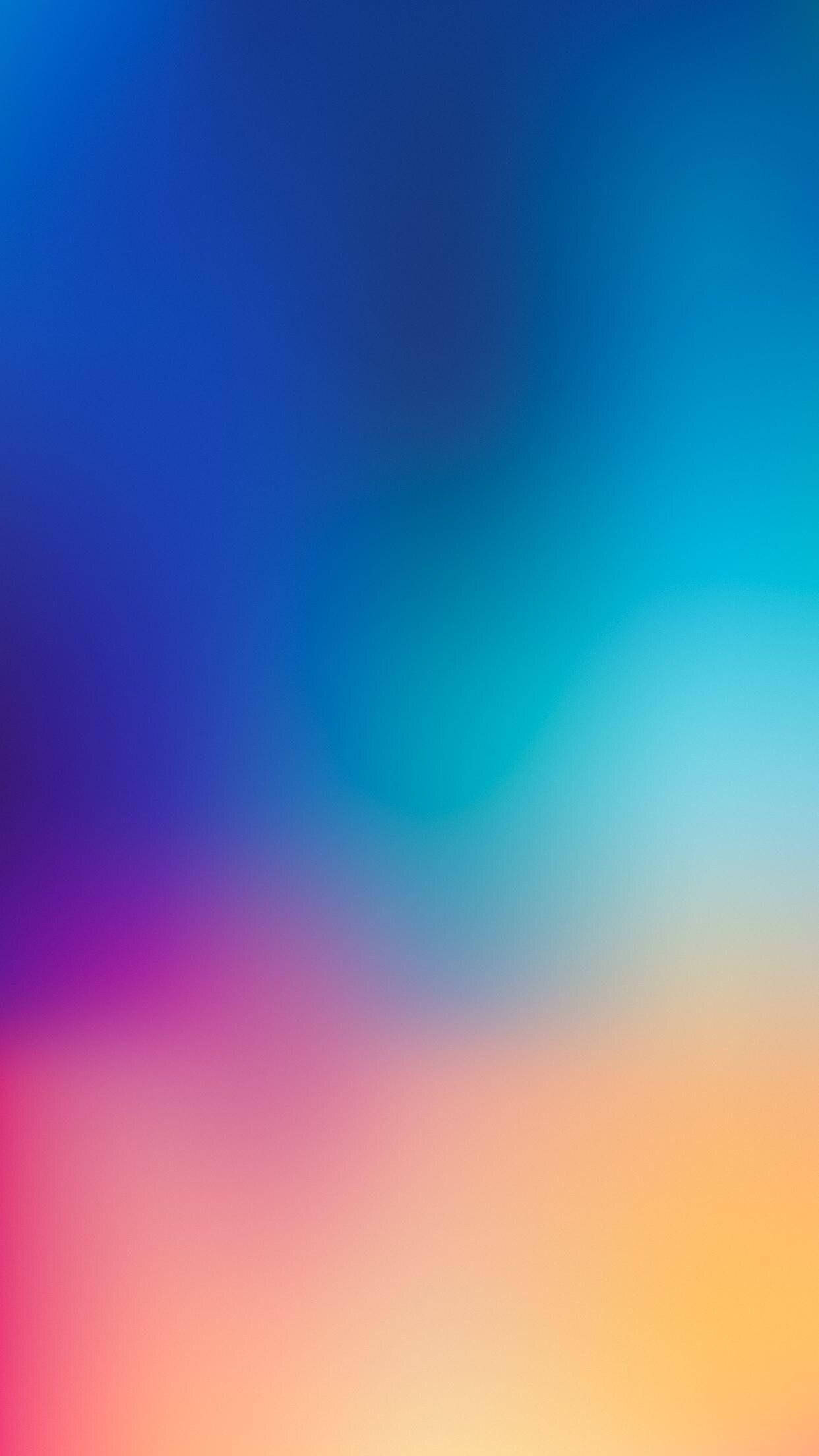 iPhone 桌布 壁紙 — 藍色、青綠色、粉紅色和橙色在畫面中柔和融合的平滑漸變。
