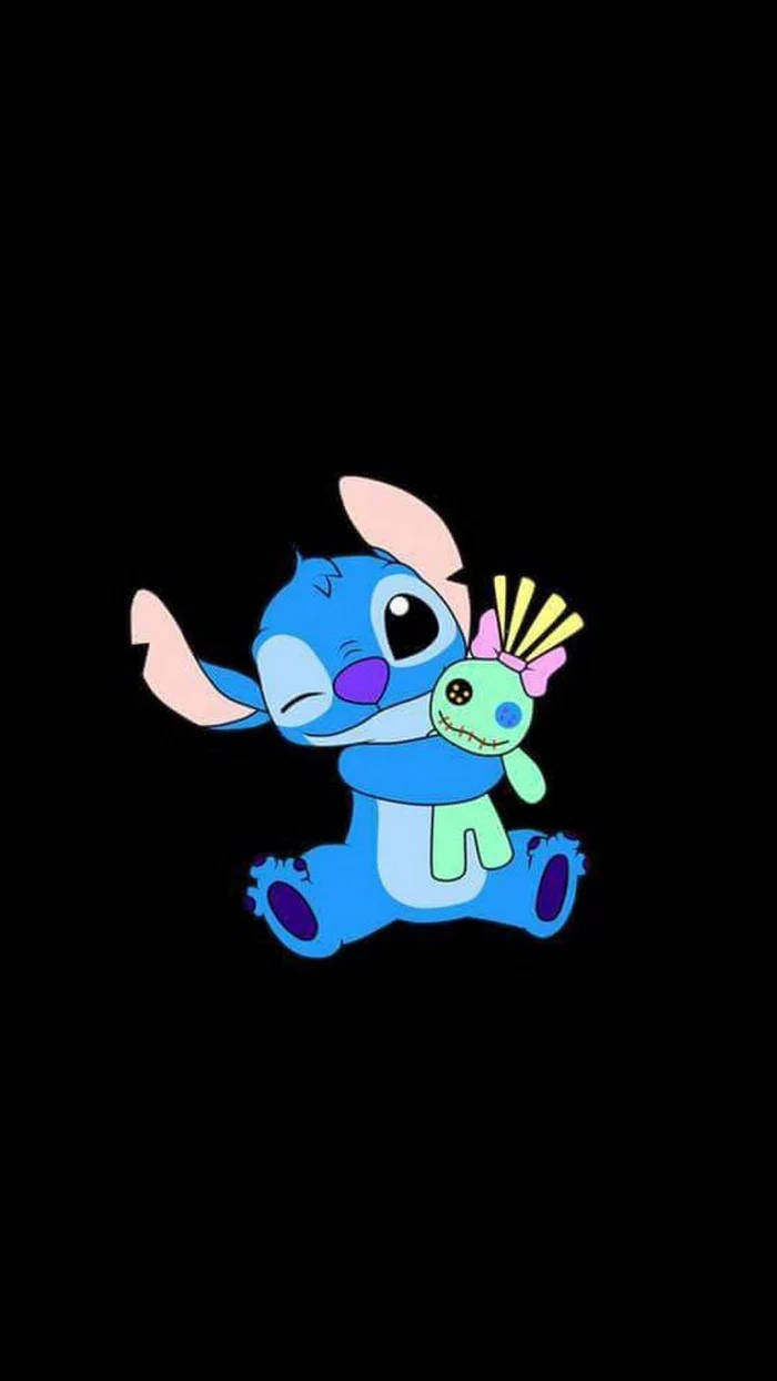 kawaii stitch 桌布 壁紙 — 藍色卡通外星人史迪奇在黑色背景前擁抱一個帶有粉紅色蝴蝶結的綠色縫製娃娃。