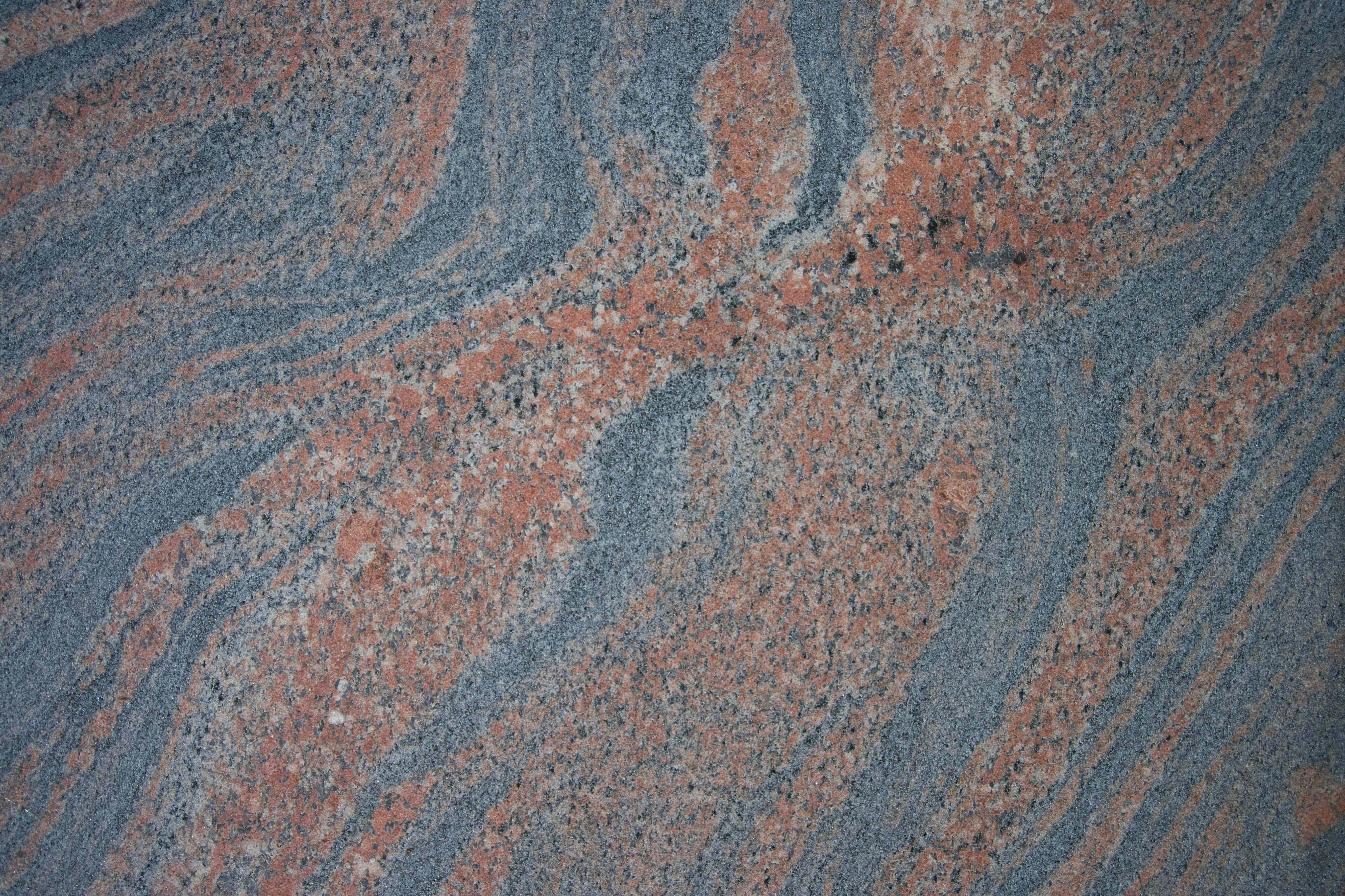 Granite 桌布 壁紙 — 藍色和橙色漩渦花崗岩的特寫，帶有斑點紋理和天然礦物圖案。