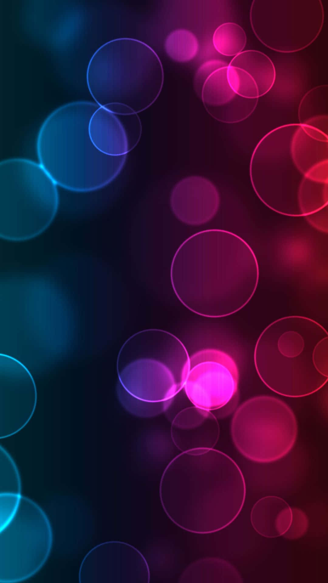 Smartphone 桌布 壁紙 — 藍色和粉紅色調的鮮豔發光圓圈漂浮在深色漸變背景上，營造出夢幻般的抽象效果。