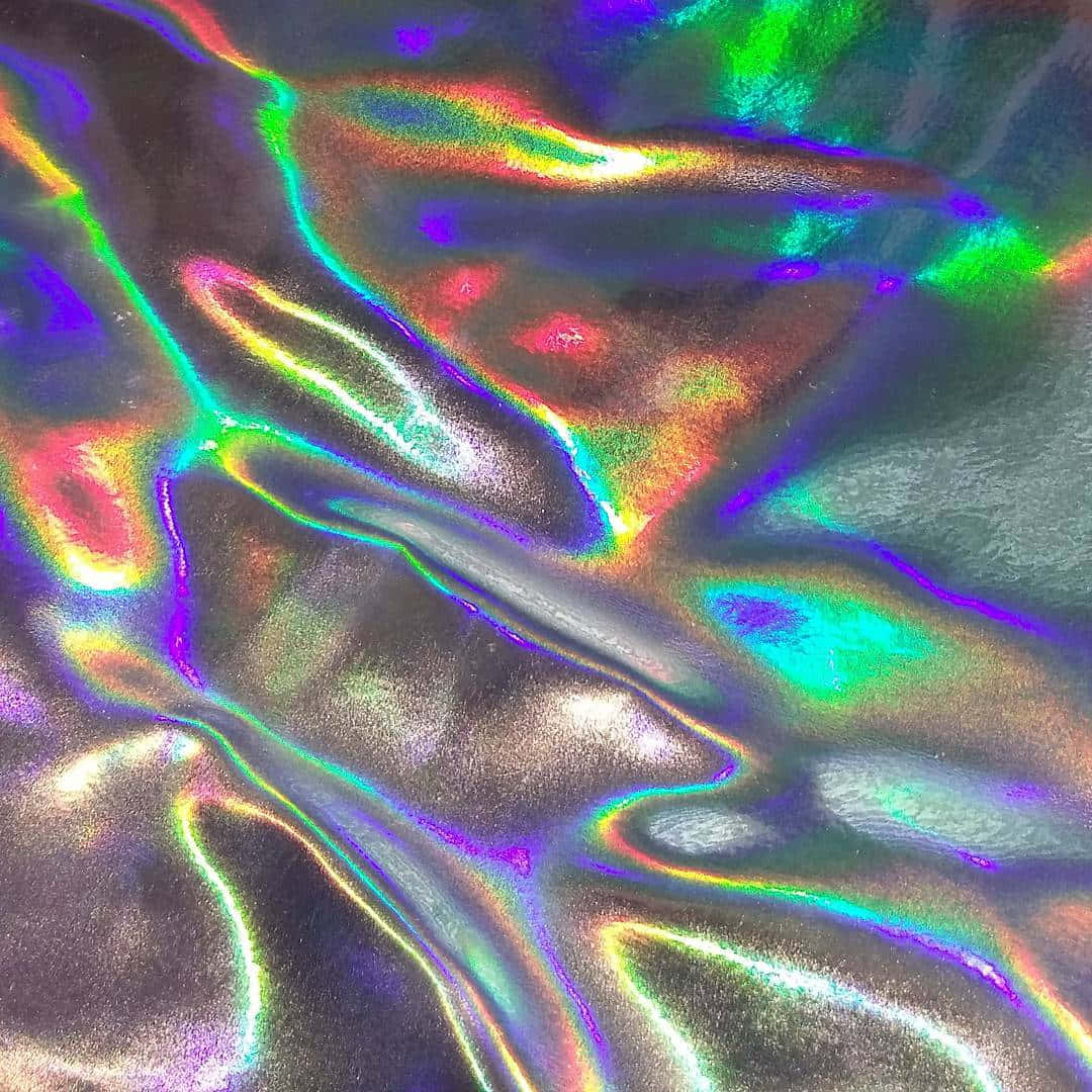 Hologram 桌布 壁紙 — 虹彩全息布料的特寫，流動的彩虹色在其紋理表面上閃爍。