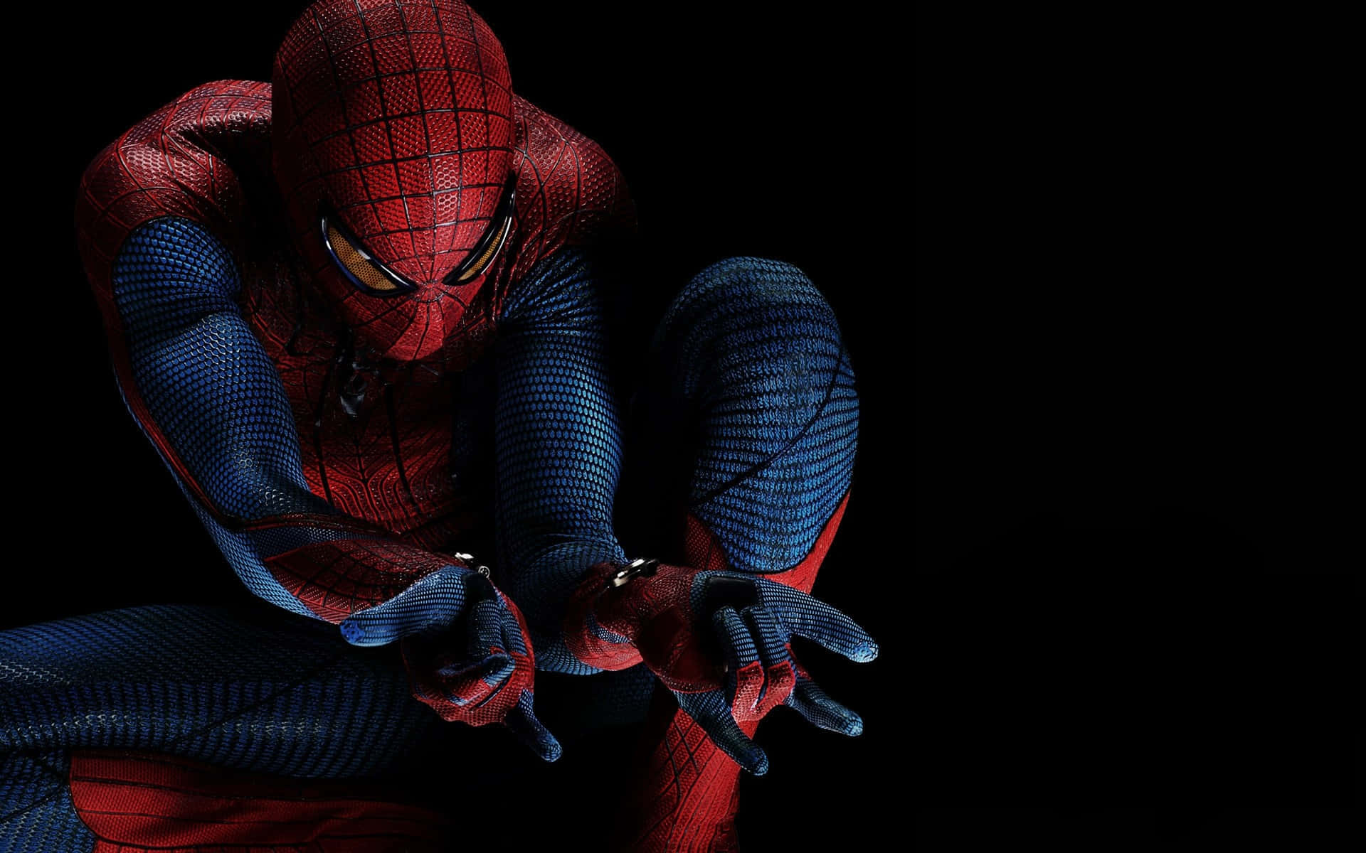 Spider Man Homecoming 桌布 壁紙 — 蜘蛛人以動態姿勢蹲在純黑色背景前，他的紅藍戰衣在戲劇性燈光下閃耀。
