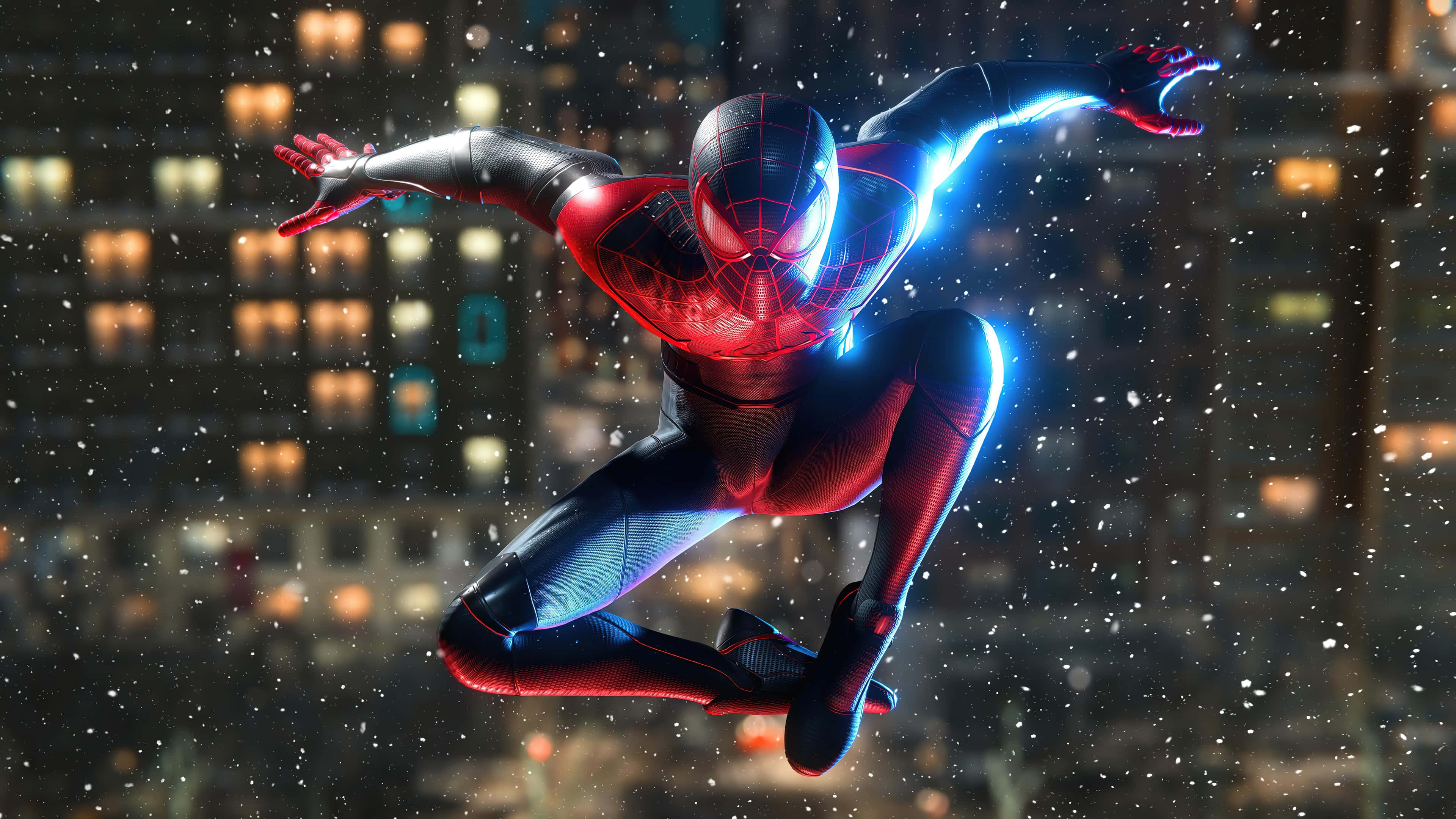 Superhero Video Games 桌布 壁紙 — 蜘蛛人穿著紅藍戰衣，在夜間於積雪的城市景觀中擺盪，身後有發光的蛛網和燈火通明的建築物。