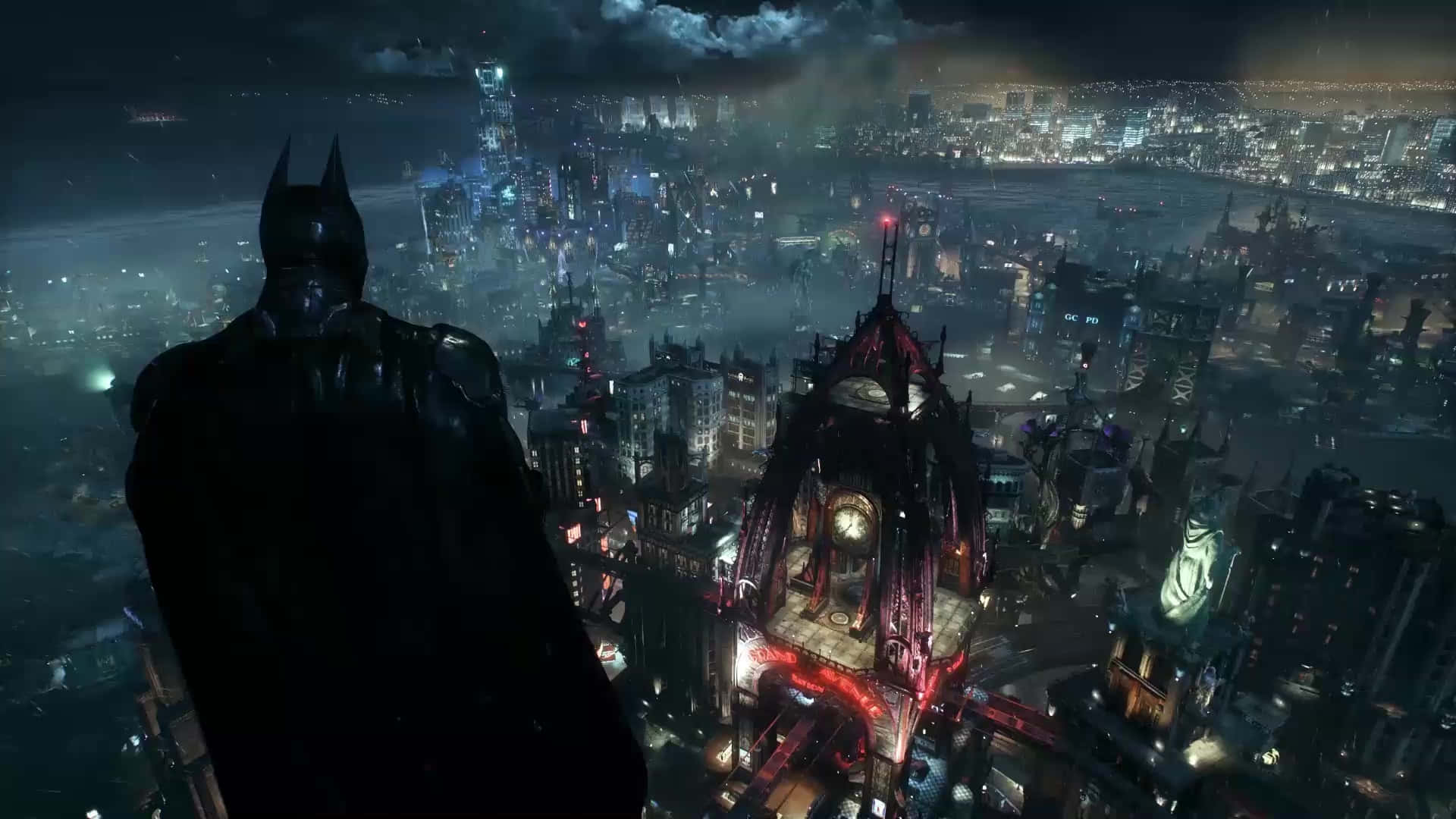 Batman City 桌布 壁紙 — 蝙蝠俠以剪影姿態站在摩天大樓頂端，俯瞰夜晚中霓虹燈閃爍、雨水浸濕的高譚市城市景觀。
