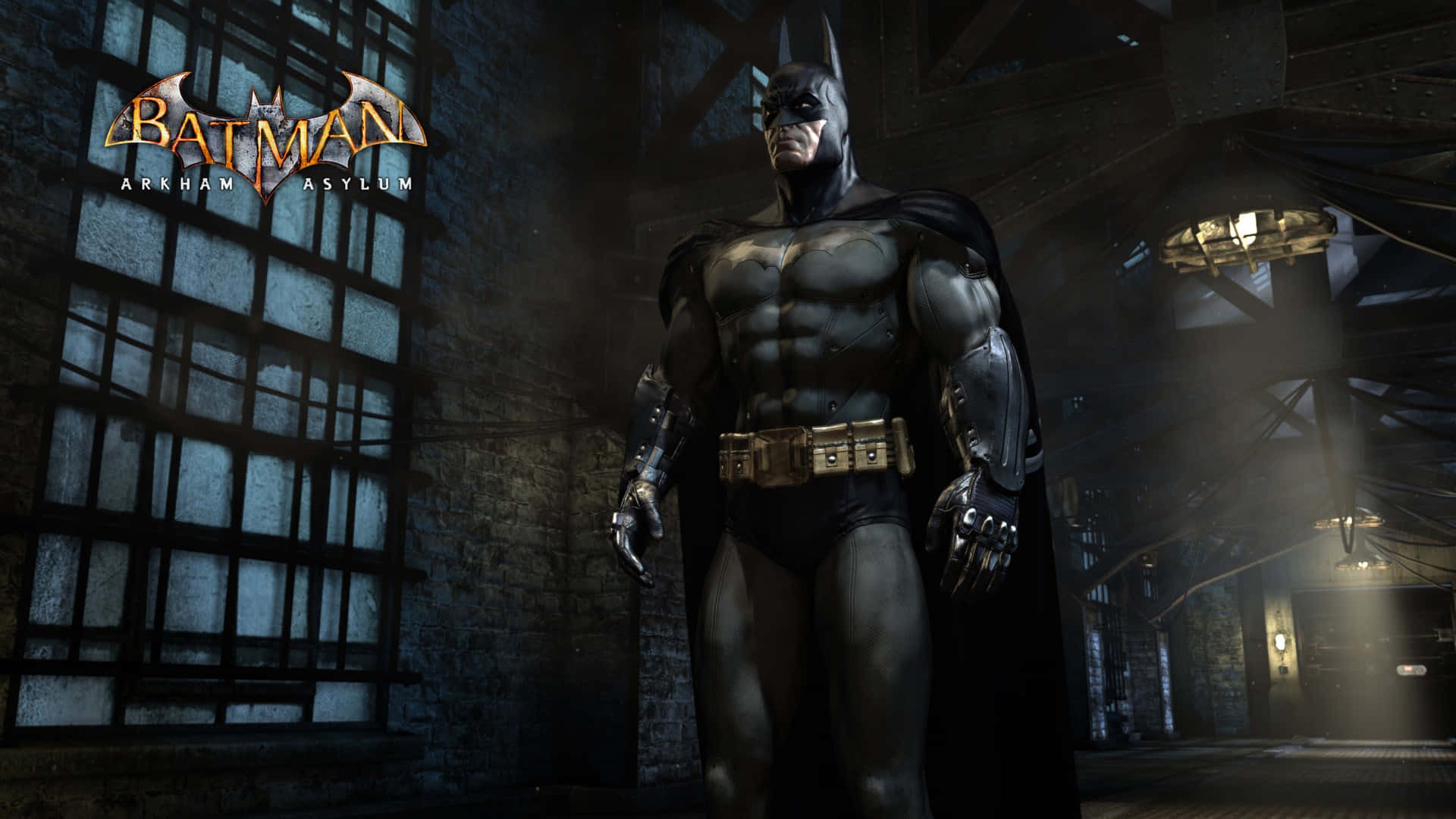 Batman Arkham Asylum 桌布 壁紙 — 蝙蝠俠在光線昏暗、陰森的瘋人院走廊中高聳站立，有鐵欄窗戶和工業橫樑。