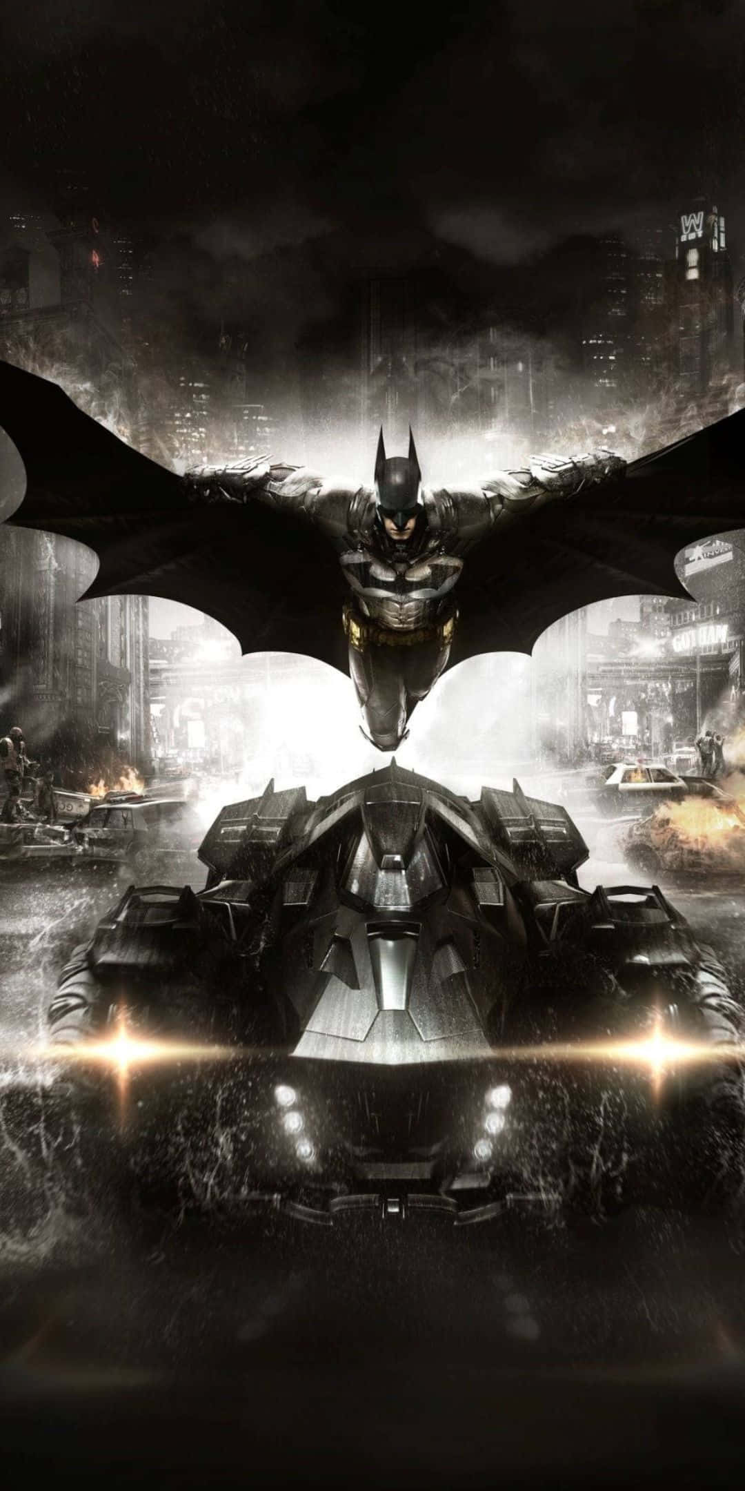 Pixel 3 Batmobile 桌布 壁紙 — 蝙蝠俠在夜間翱翔於其裝甲蝙蝠車之上，背景是雨濕的高譚市天際線。