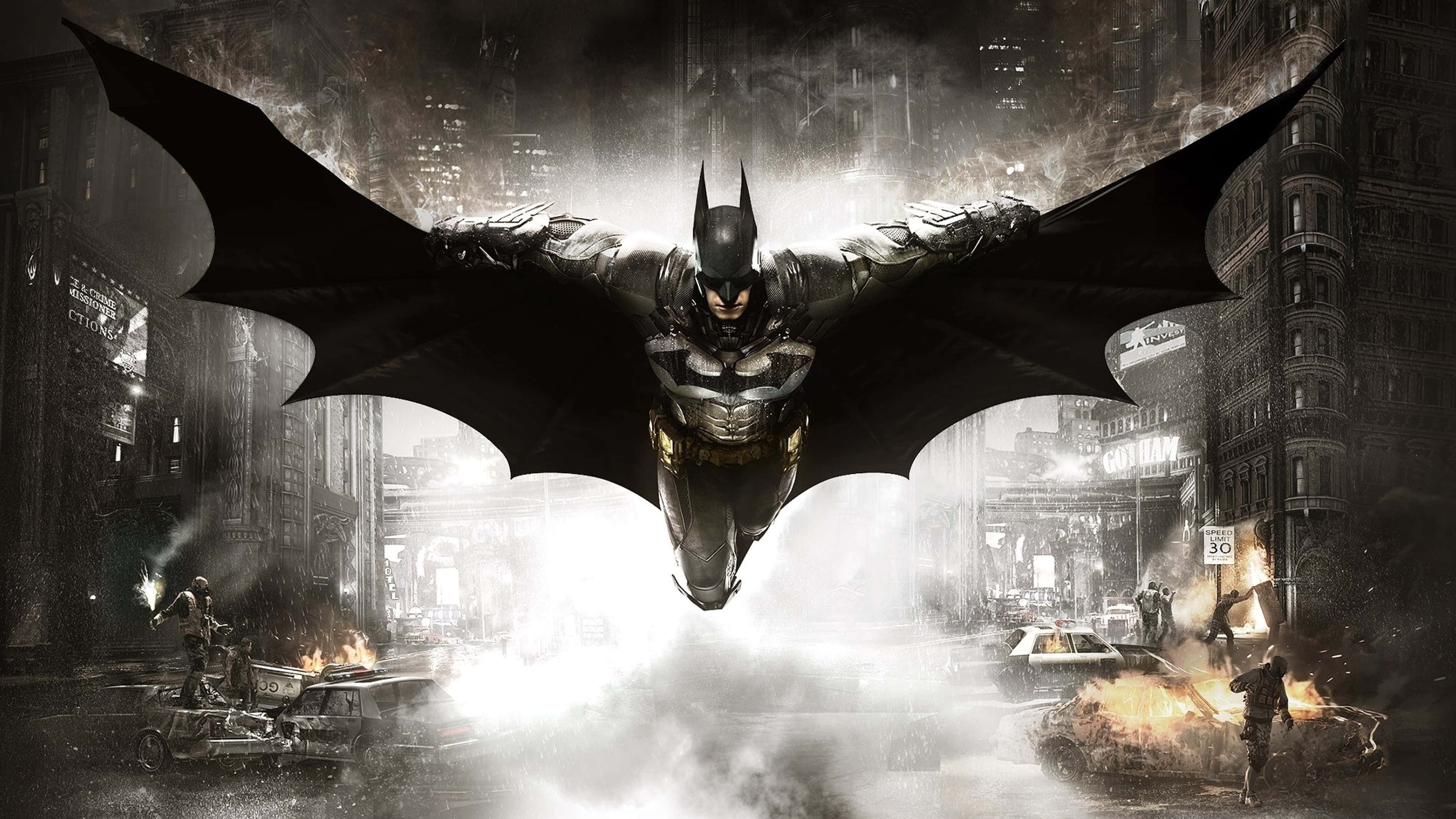 Batman City 桌布 壁紙 — 蝙蝠俠在濕透的高譚市景觀中翱翔，下方爆發爆炸和混亂。
