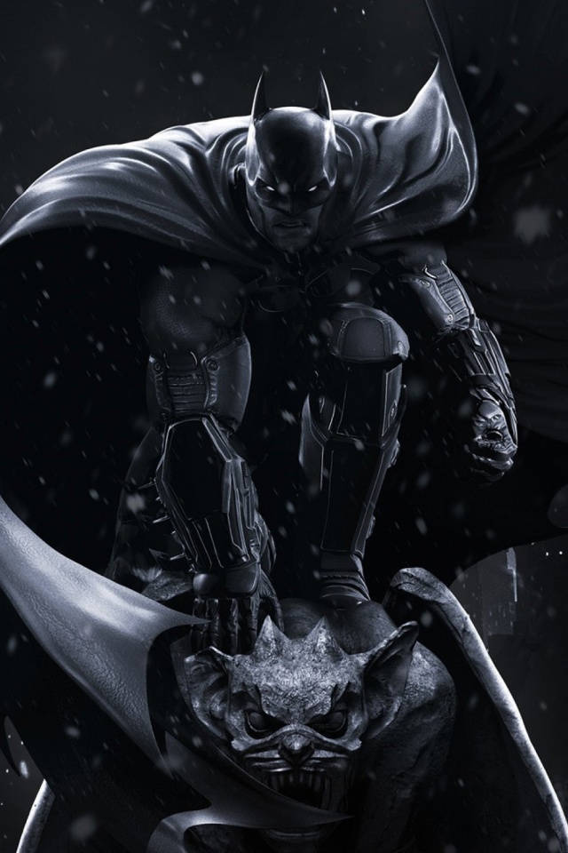 Arkham 桌布 壁紙 — 蝙蝠俠在雪夜中威風凜凜地站立，斗篷飄揚，手持蝙蝠形面具，背景漆黑。