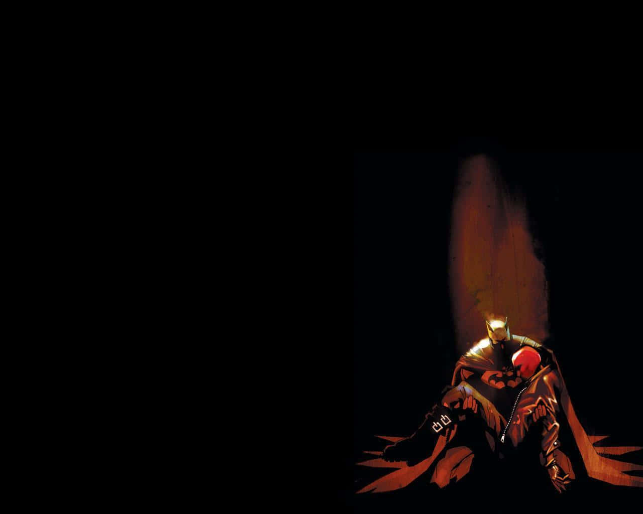 Batman Under The Red Hood 桌布 壁紙 — 蝙蝠俠獨自坐在黑暗中，一道溫暖的光束照亮了他的斗篷和頭罩。