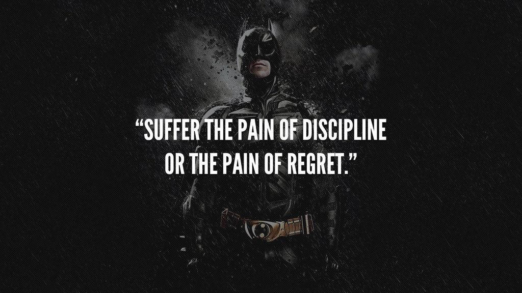 batman quotes 桌布 壁紙 — 蝙蝠俠站在一個被雨淋濕的黑暗場景中，上面覆蓋著一句話：「承受紀律的痛苦或後悔的痛苦」。