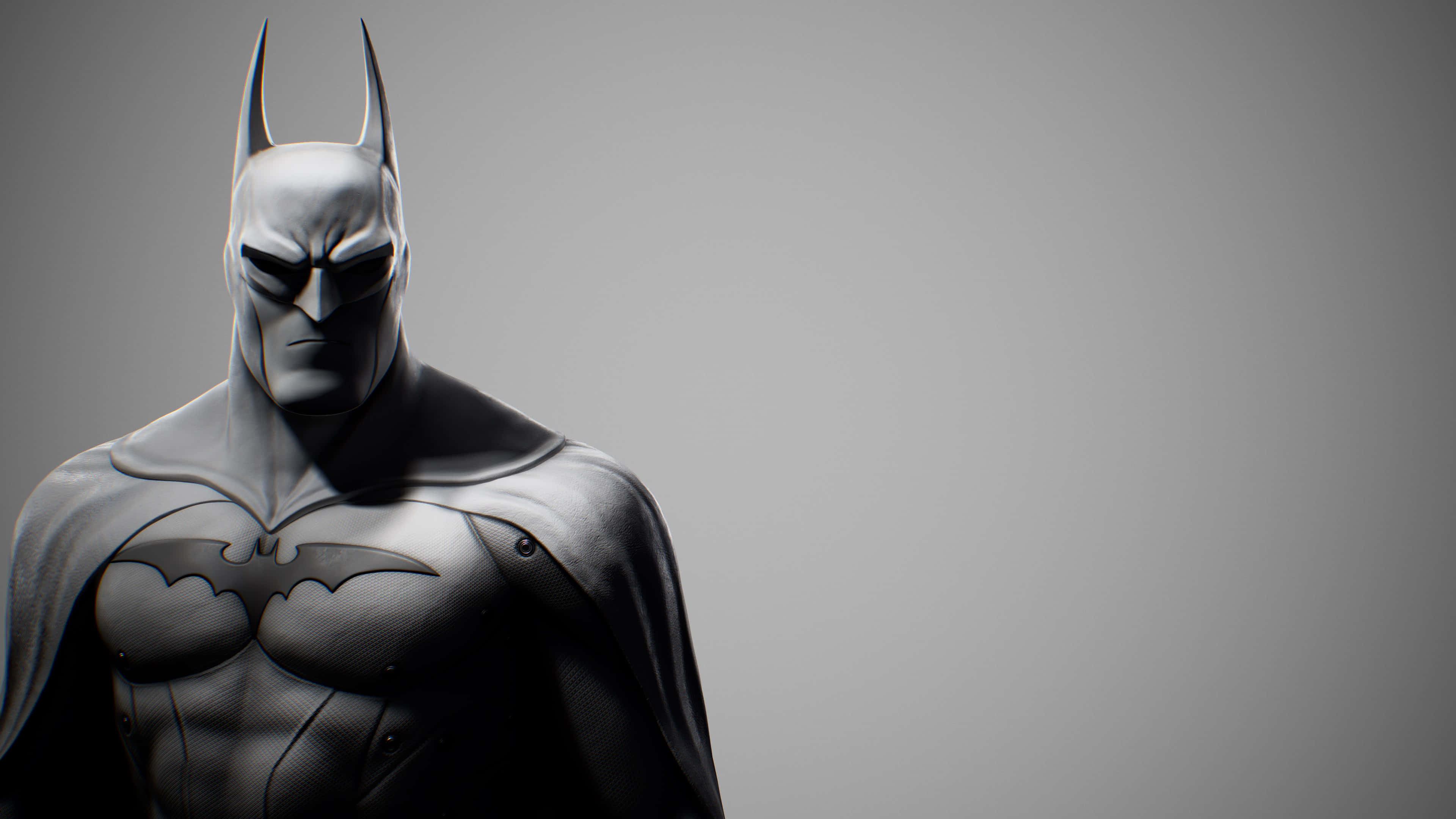 Batman Arkham City 桌布 壁紙 — 蝙蝠俠站在簡樸的灰色攝影棚中，神情專注，身穿肌肉感十足的裝甲服。