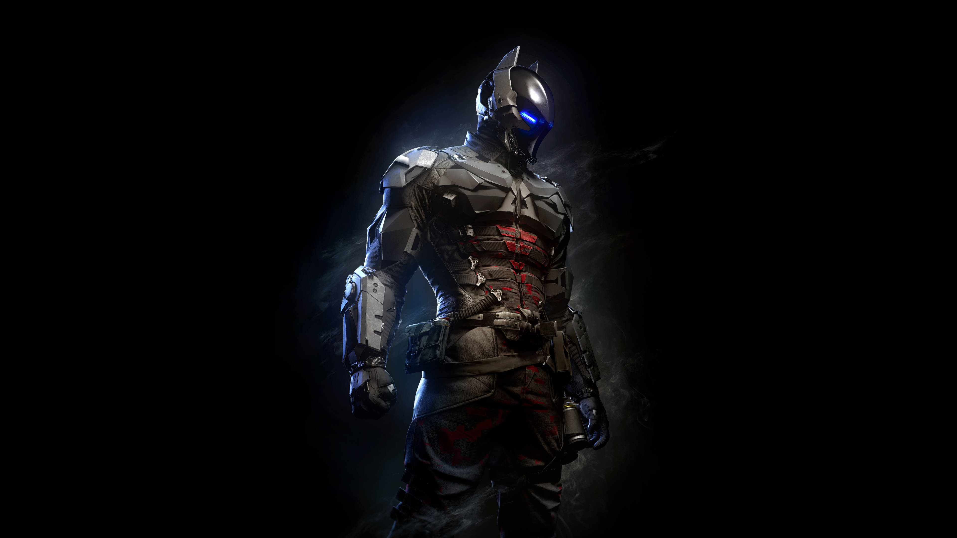 game 桌布 壁紙 — 蝙蝠俠站在陰影黑暗中，裝甲服上有發光的藍色眼睛和紅色點綴。