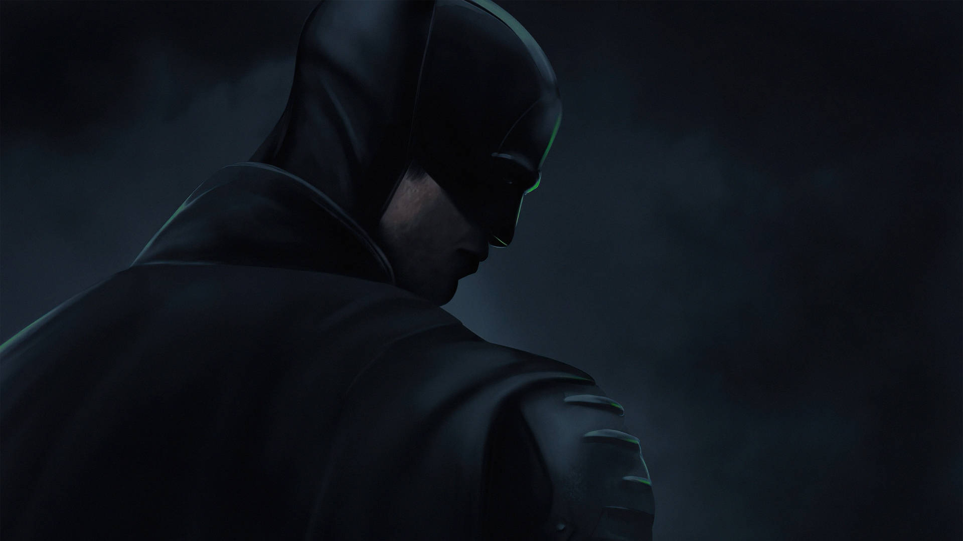 The Batman 桌布 壁紙 — 蝙蝠俠站在陰暗的陰影中，披風飄動，他低頭沉思，神情肅穆。
