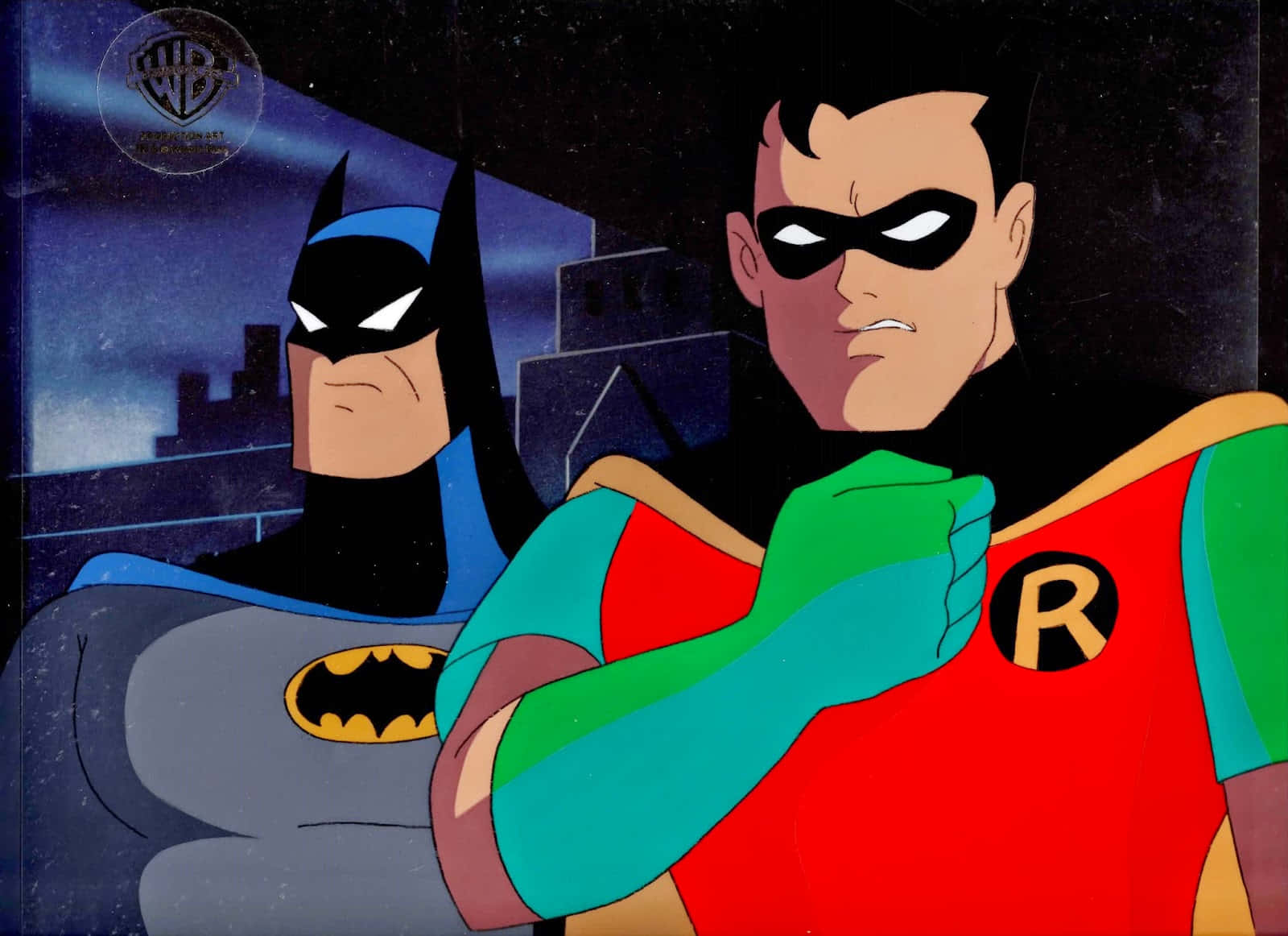 Batman Vs Robin 桌布 壁紙 — 蝙蝠俠與羅賓在夜間城市景觀中並肩而立，羅賓的拳頭高舉，充滿決心。
