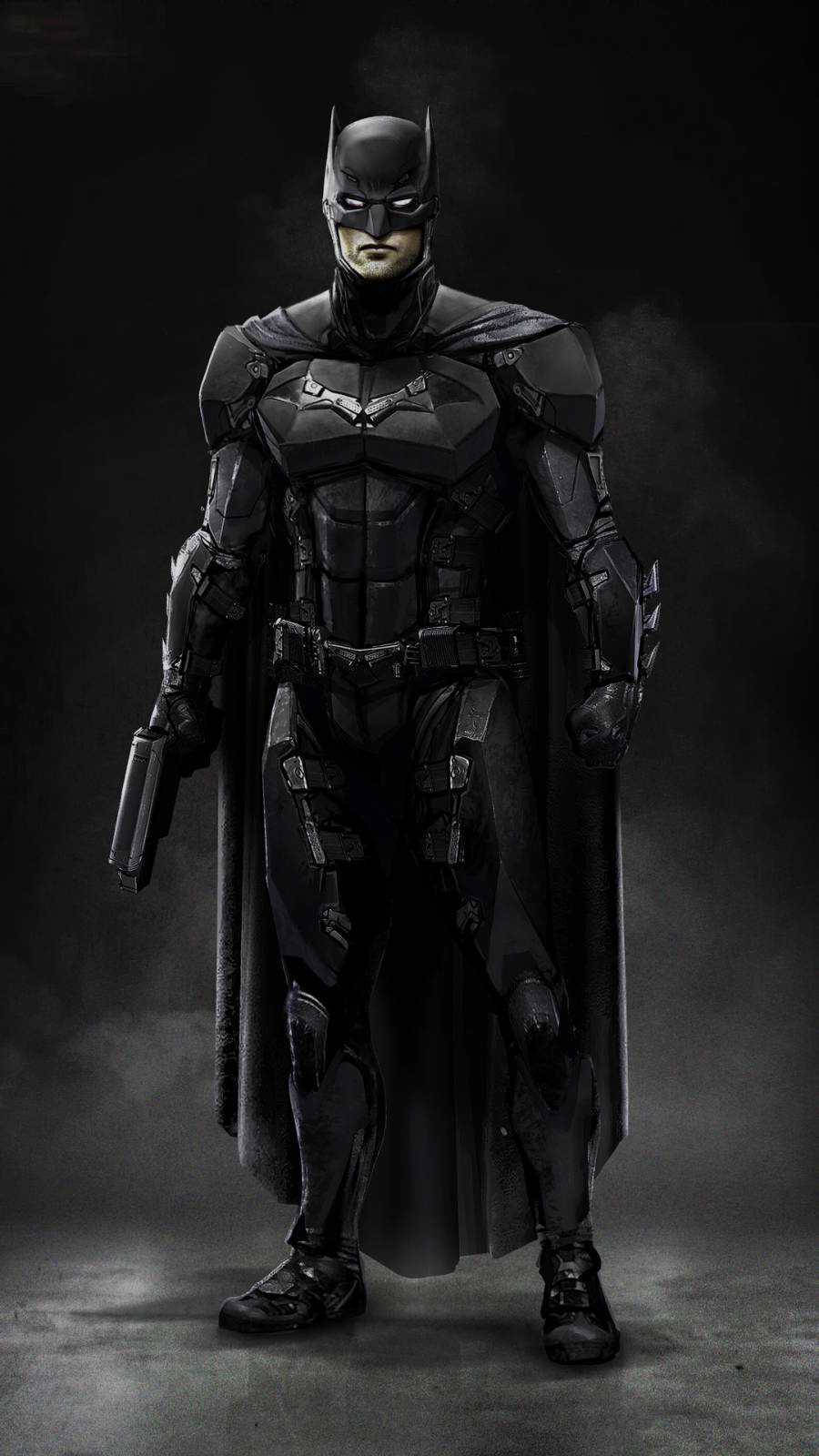 The Batman iPhone 桌布 壁紙 — 蝙蝠俠身穿裝甲服、披風和頭罩，在黑暗粗糙的攝影棚中手持槍枝站立。