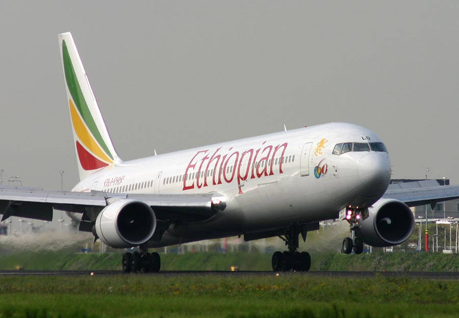 飛機 桌布 壁紙 — 衣索比亞航空飛機降落在跑道上，起落架放下，引擎在灰色天空下轟鳴。
