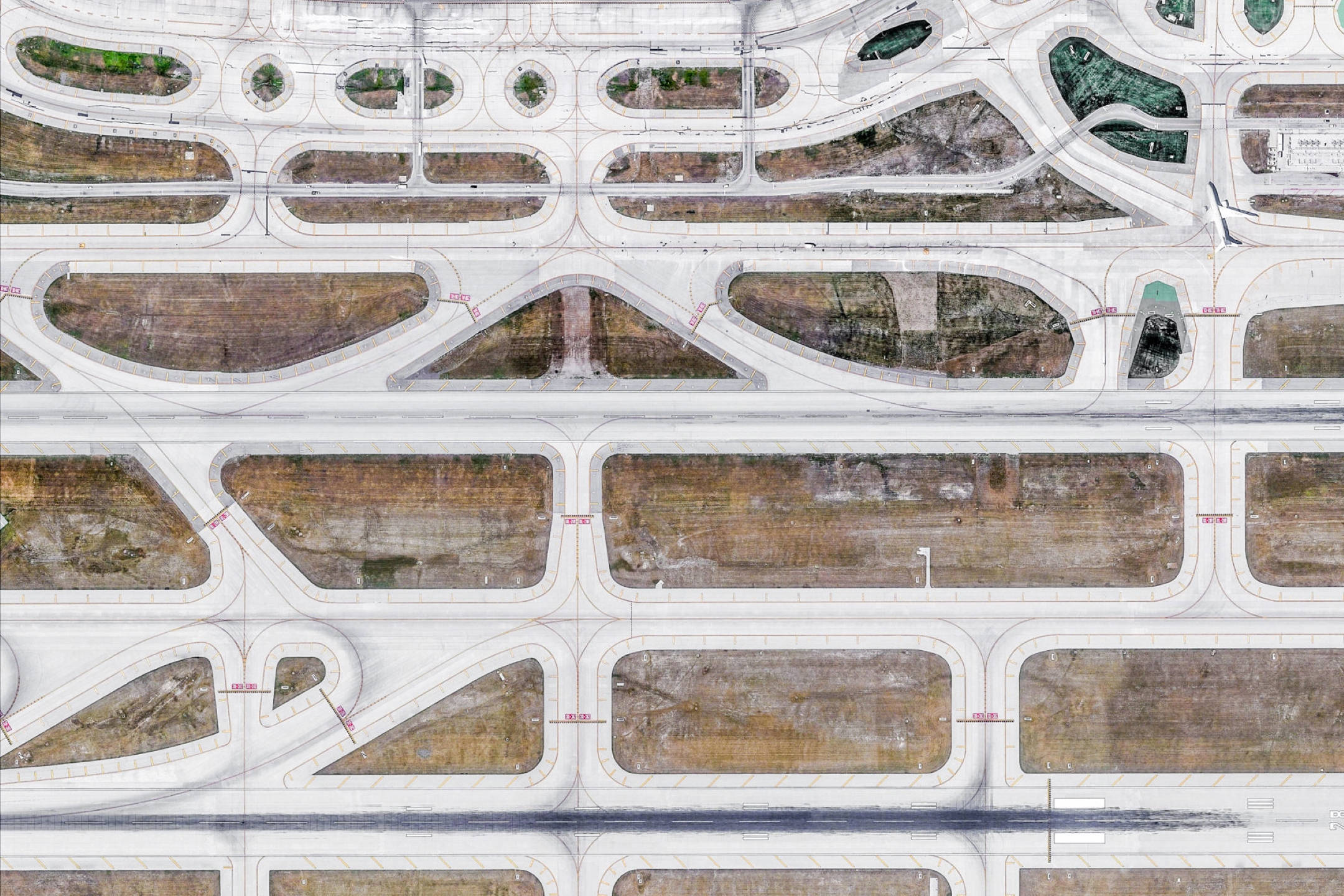 Google 地球 桌布 壁紙 — 複雜高速公路交匯處的鳥瞰圖，車道之間有彎曲的混凝土道路和乾燥的泥土斑塊。