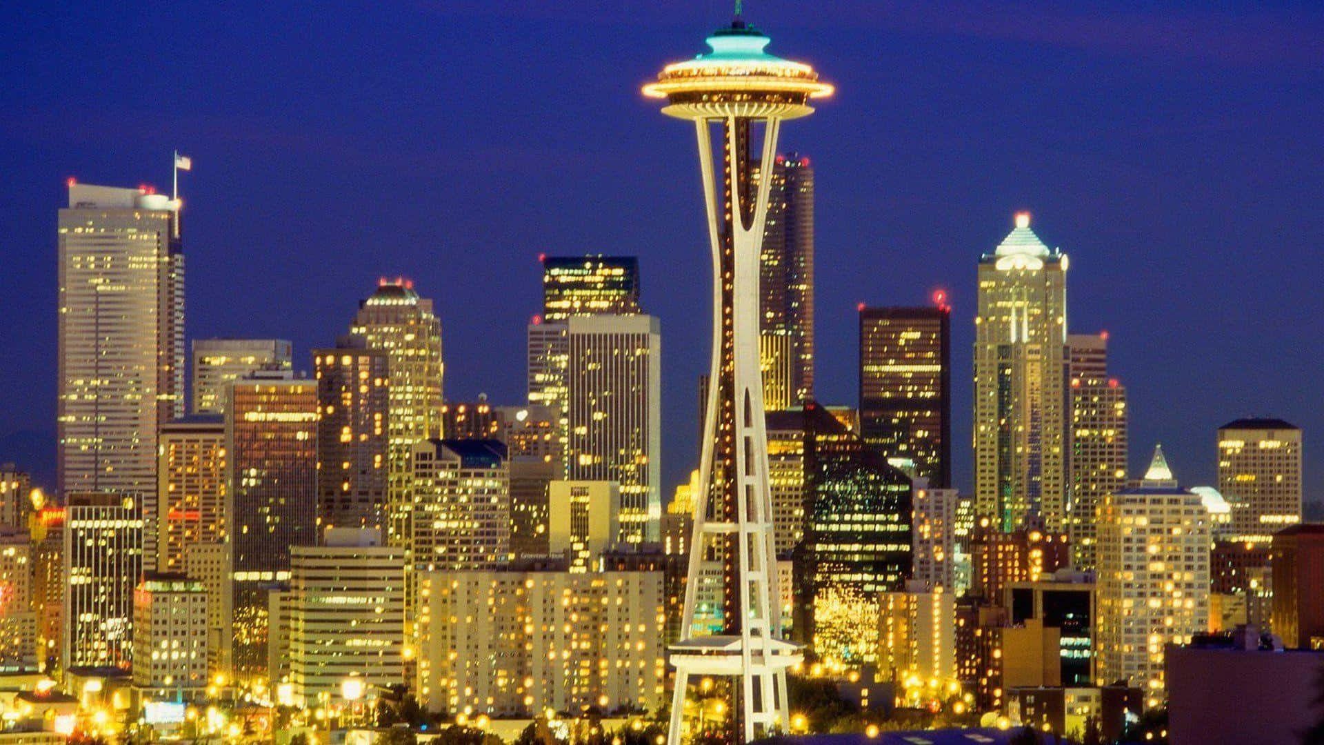 Seattle At Night 桌布 壁紙 — 西雅圖天際線在黃昏時分，太空針塔在深藍色天空下閃耀，城市燈光閃爍。