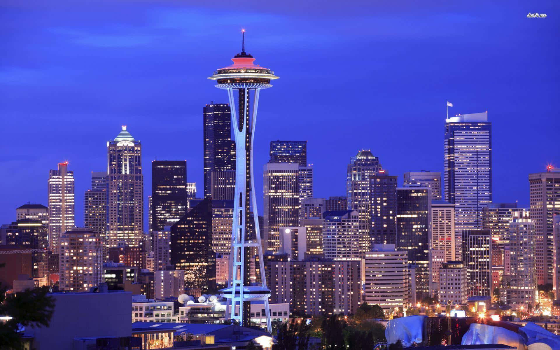 Seattle At Night 桌布 壁紙 — 西雅圖暮色天際線，太空針塔在深藍色天空中閃耀。