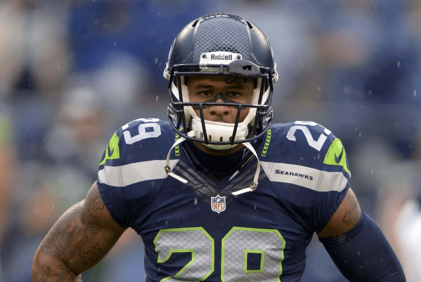 NFL 桌布 壁紙 — 西雅圖海鷹隊美式足球員20號在雨中比賽時透過頭盔凝視著前方。