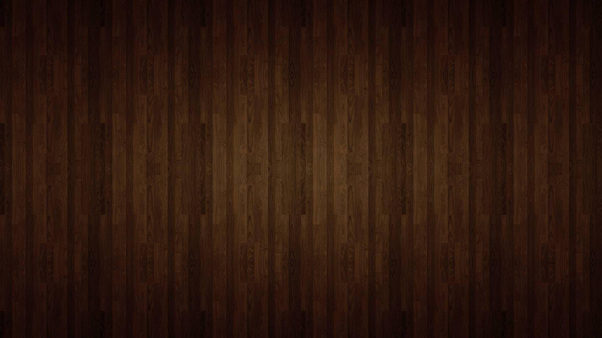 Wood Texture 桌布 壁紙 — 豐富的深棕色木地板，帶有天然木紋圖案和微妙的燈光變化。