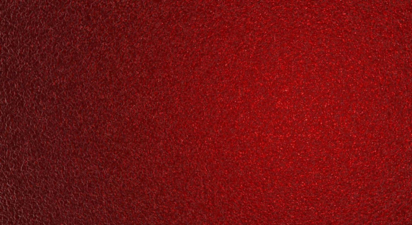 Red Texture 桌布 壁紙 — 豐富紋理的深紅色表面，帶有微妙的閃亮高光和柔和漸變照明。