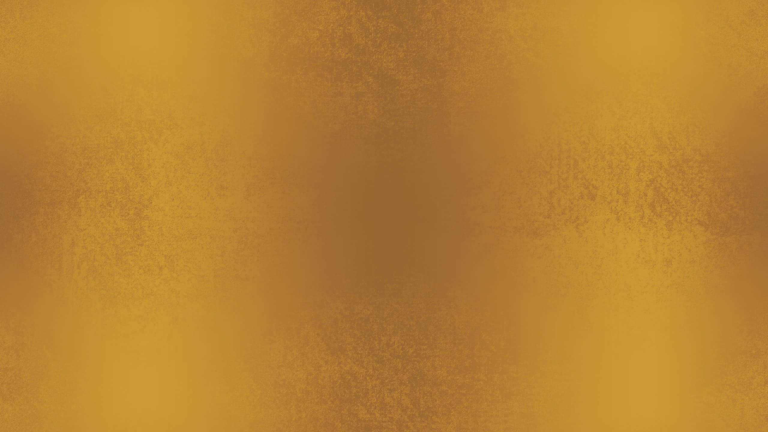 Gold Texture 桌布 壁紙 — 豐富紋理的金色漸變背景，帶有細微斑點和柔和光線變化。