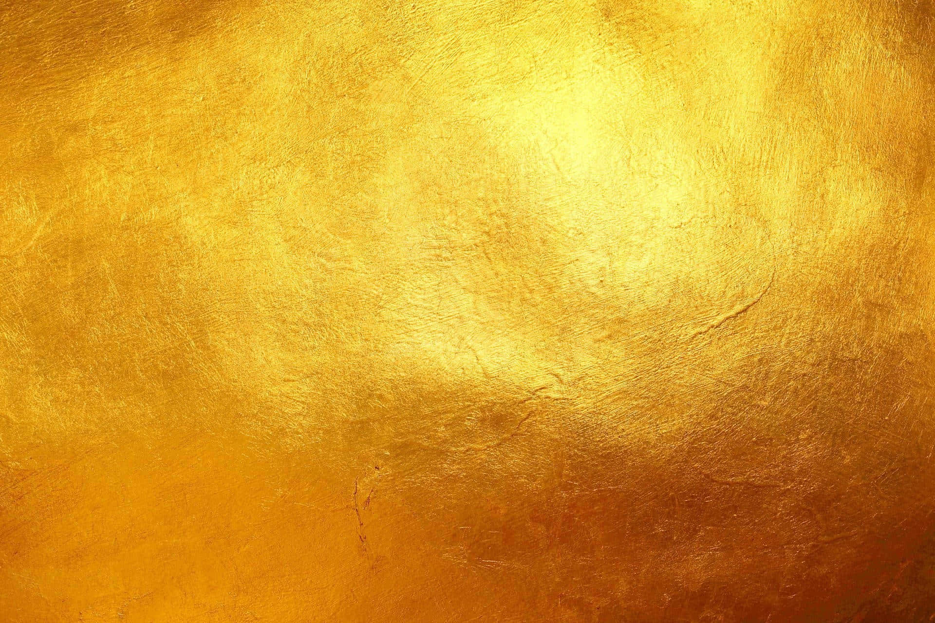 Gold Texture 桌布 壁紙 — 豐富紋理的金色表面，帶有溫暖漸變和細微瑕疵，柔和發光。