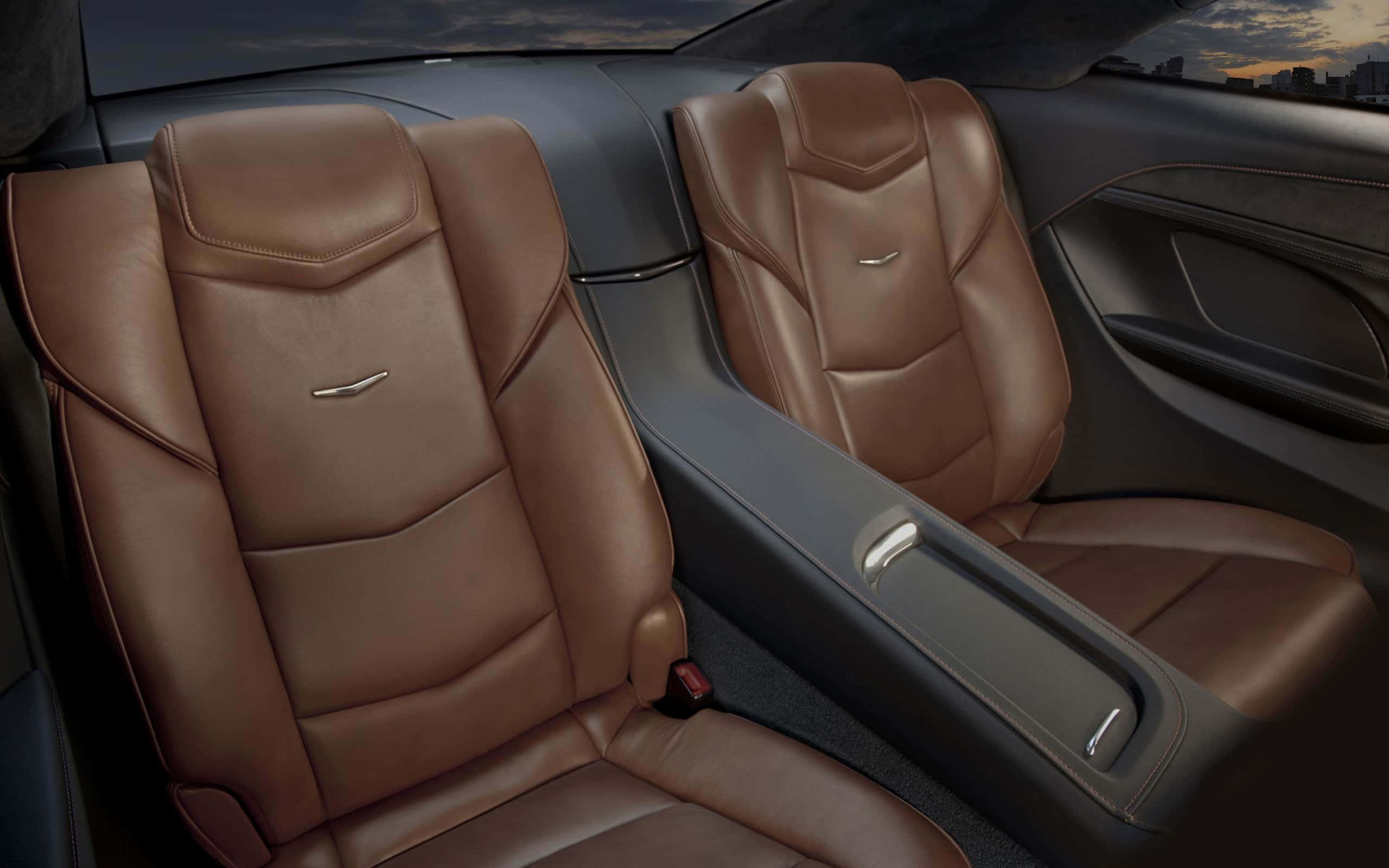 Cadillac Elr 桌布 壁紙 — 豪華車內裝，配備棕褐色皮革座椅和時尚儀表板，背景為暮色城市天際線。