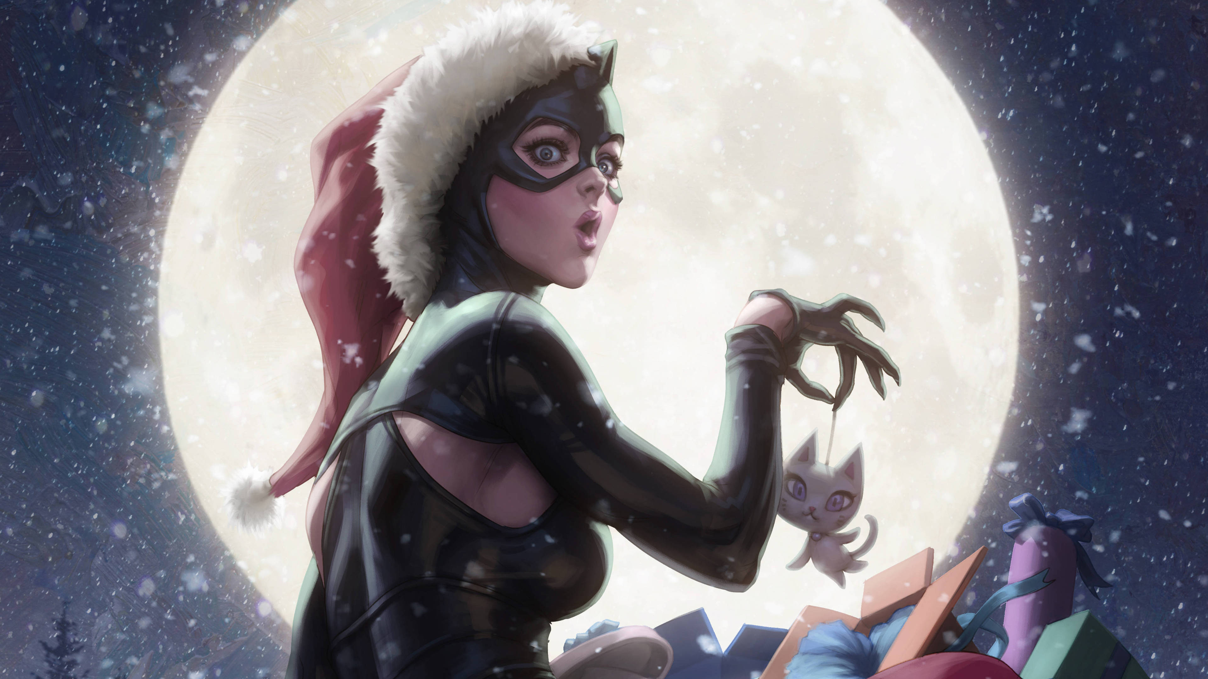 Catwoman 桌布 壁紙 — 貓女戴上聖誕帽，抱著一隻小貓，背景是雪夜天空，身後有一輪巨大的月亮。