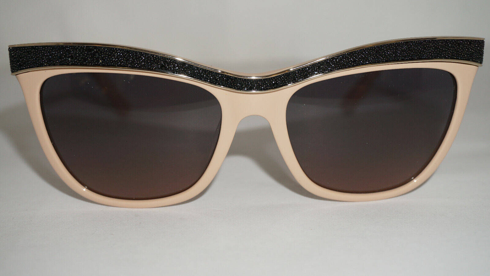 glasses 桌布 壁紙 — 貓眼太陽眼鏡，米色鏡框，黑色閃亮頂框，放在純白表面上。