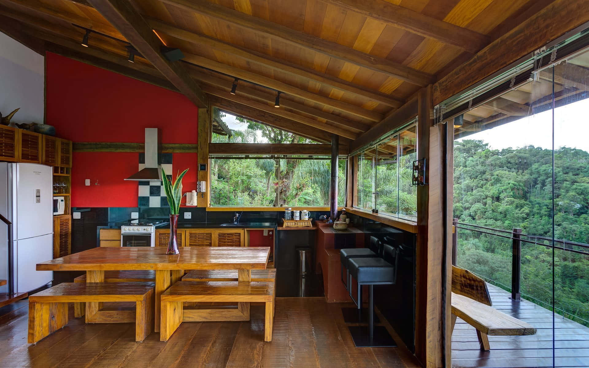 Dining Room 桌布 壁紙 — 質樸的木製廚房，紅色牆壁，大型玻璃窗可俯瞰鬱鬱蔥蔥的綠色森林。