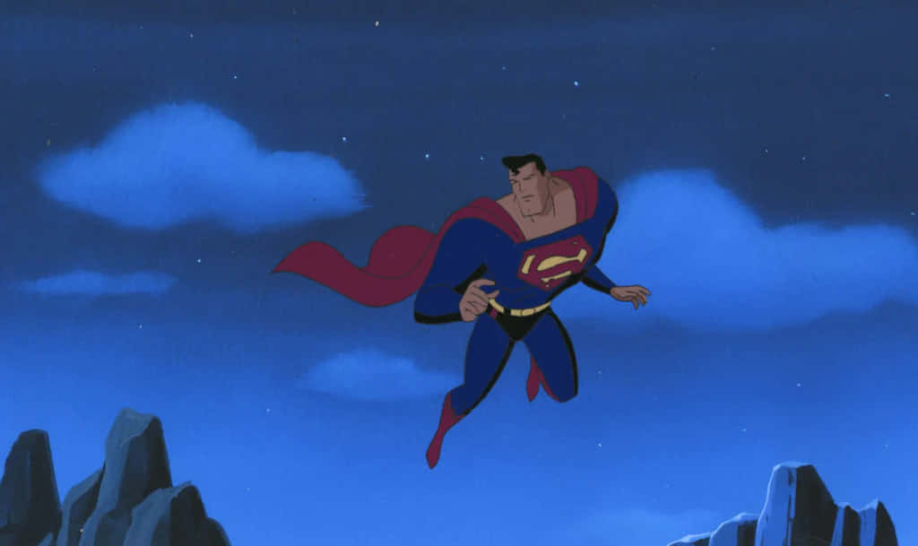 Superman The Animated Series 桌布 壁紙 — 超人在繁星夜空中翱翔，披風在崎嶇的山頂上飄揚。
