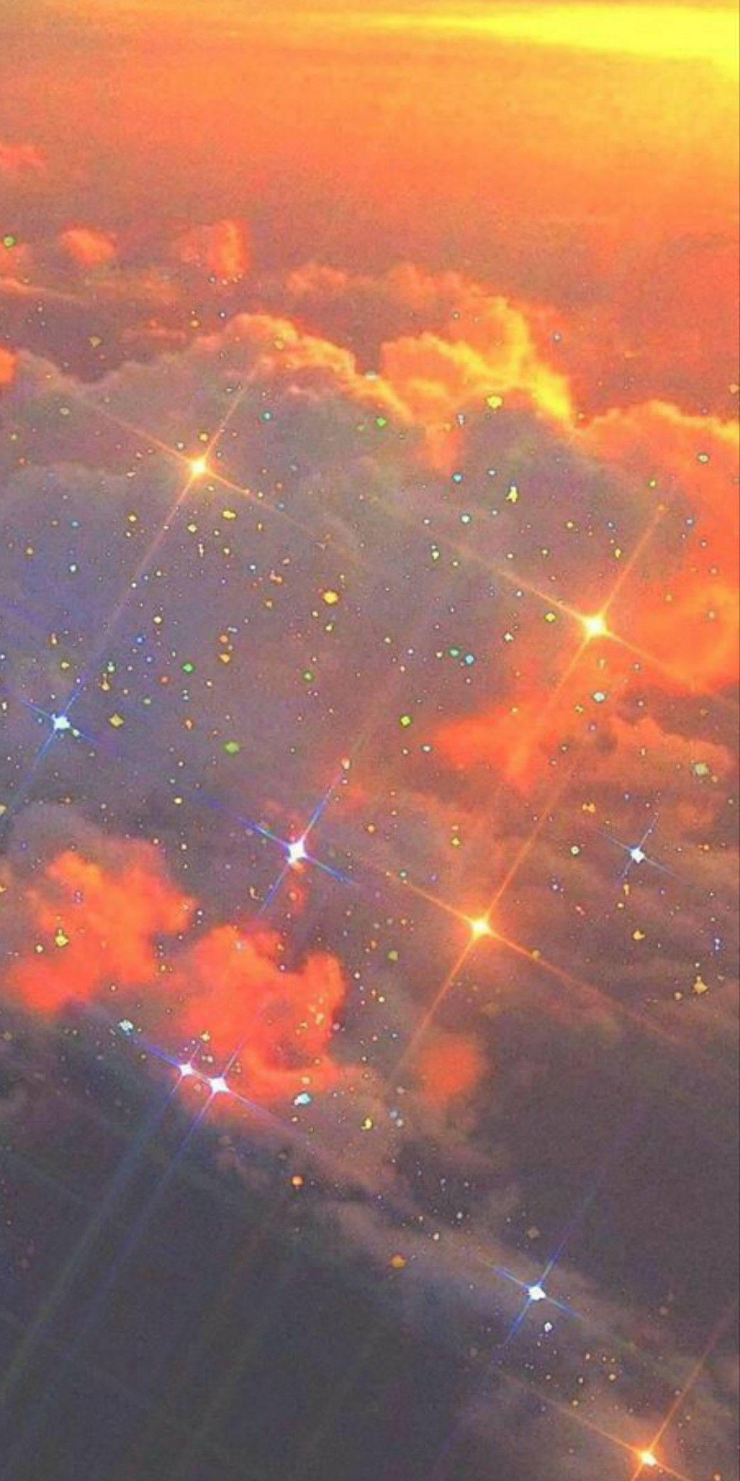 Screen 桌布 壁紙 — 超現實的天空，帶有發光的橙色雲彩和閃爍的星星，營造出夢幻般的天體場景。
