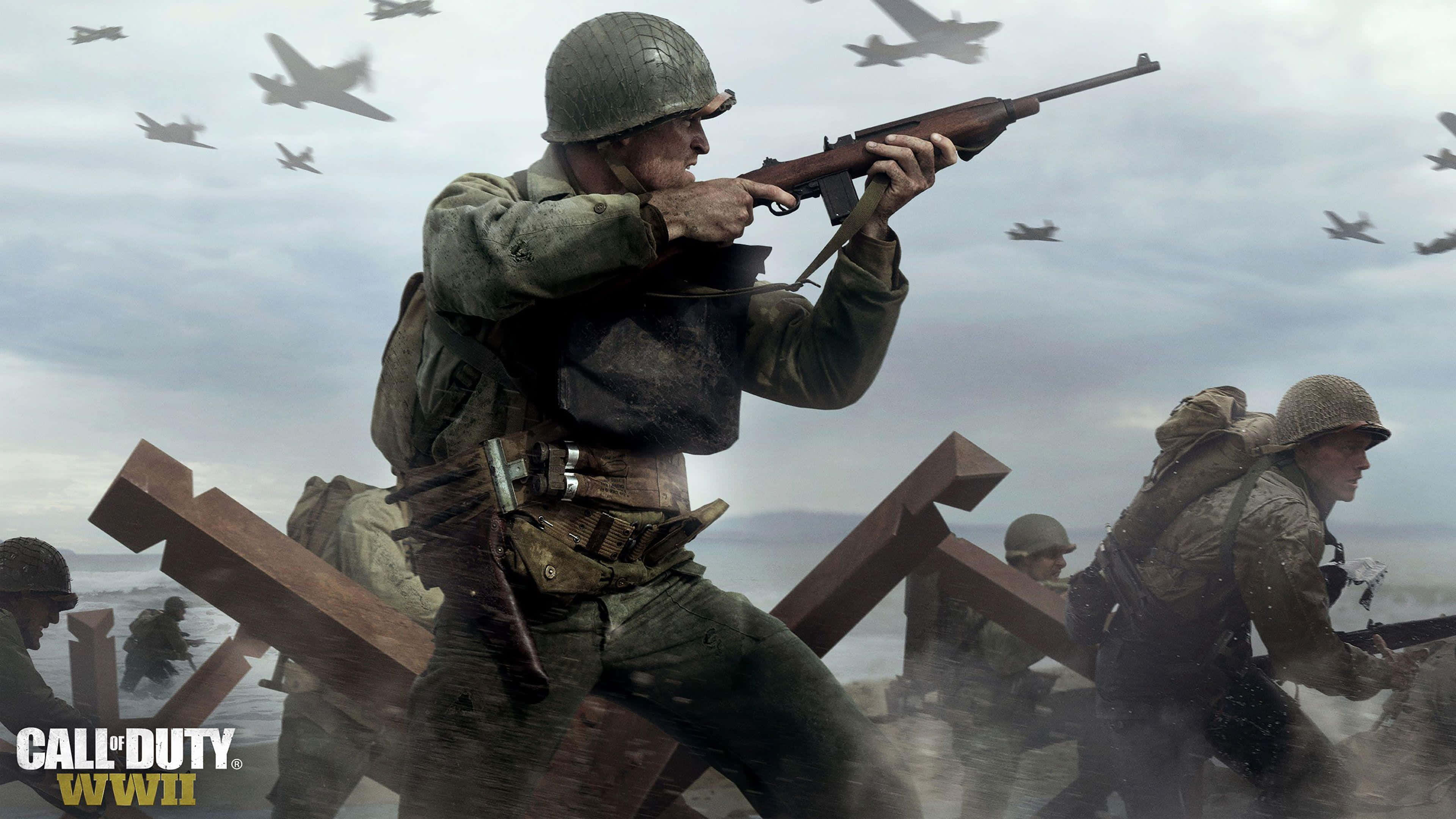 World War 2 桌布 壁紙 — 身穿二戰裝備的士兵在設有木製路障的戰場上前進，戰鬥機在灰色的天空中飛過。