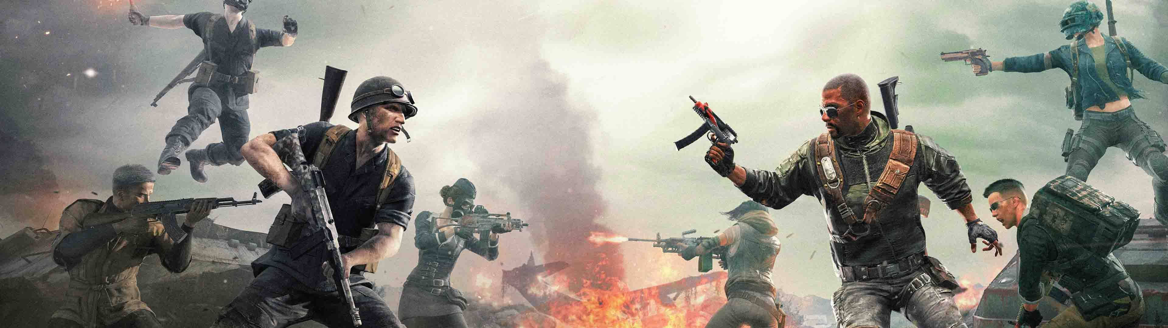Gaming Dual Screen 桌布 壁紙 — 身穿戰鬥裝備的士兵在煙霧和火焰中跳躍並開火，呈現混亂的戰場場景。