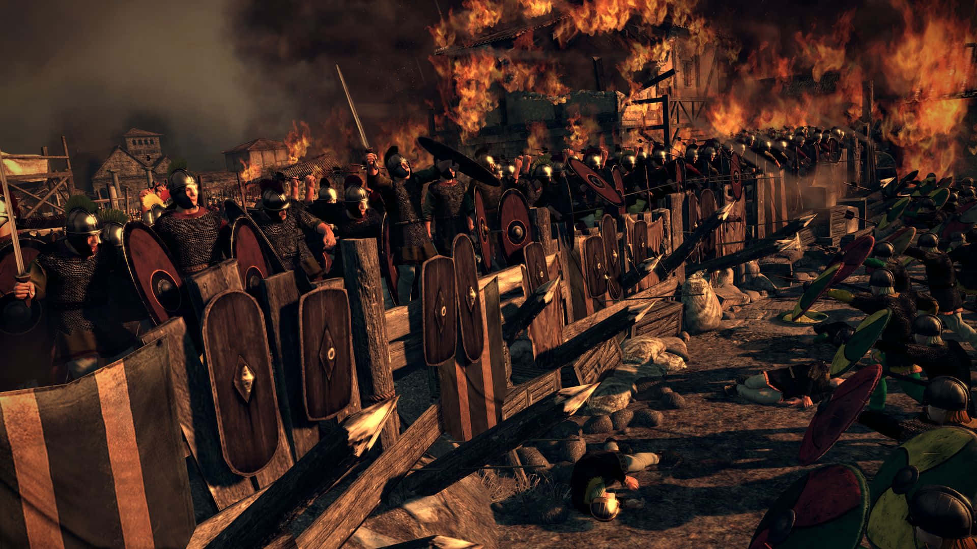 Total War Attila 桌布 壁紙 — 身穿盔甲的羅馬士兵在燃燒的建築物和倒下的戰友中形成盾牆，戰場一片混亂。