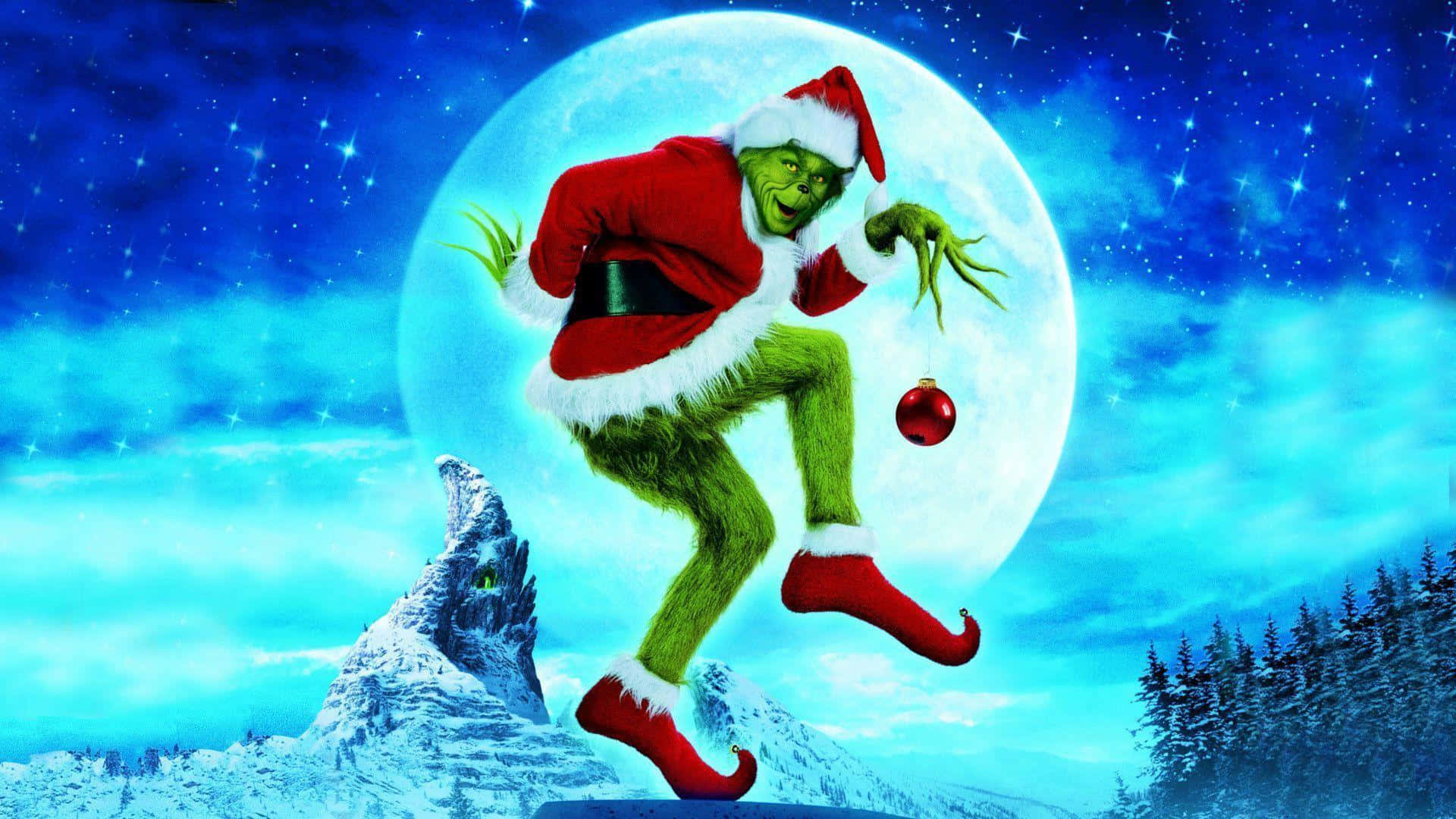 The Grinch 桌布 壁紙 — 身穿紅色聖誕老人服的鬼靈精，在滿月背襯的星空下歡快地跳躍。