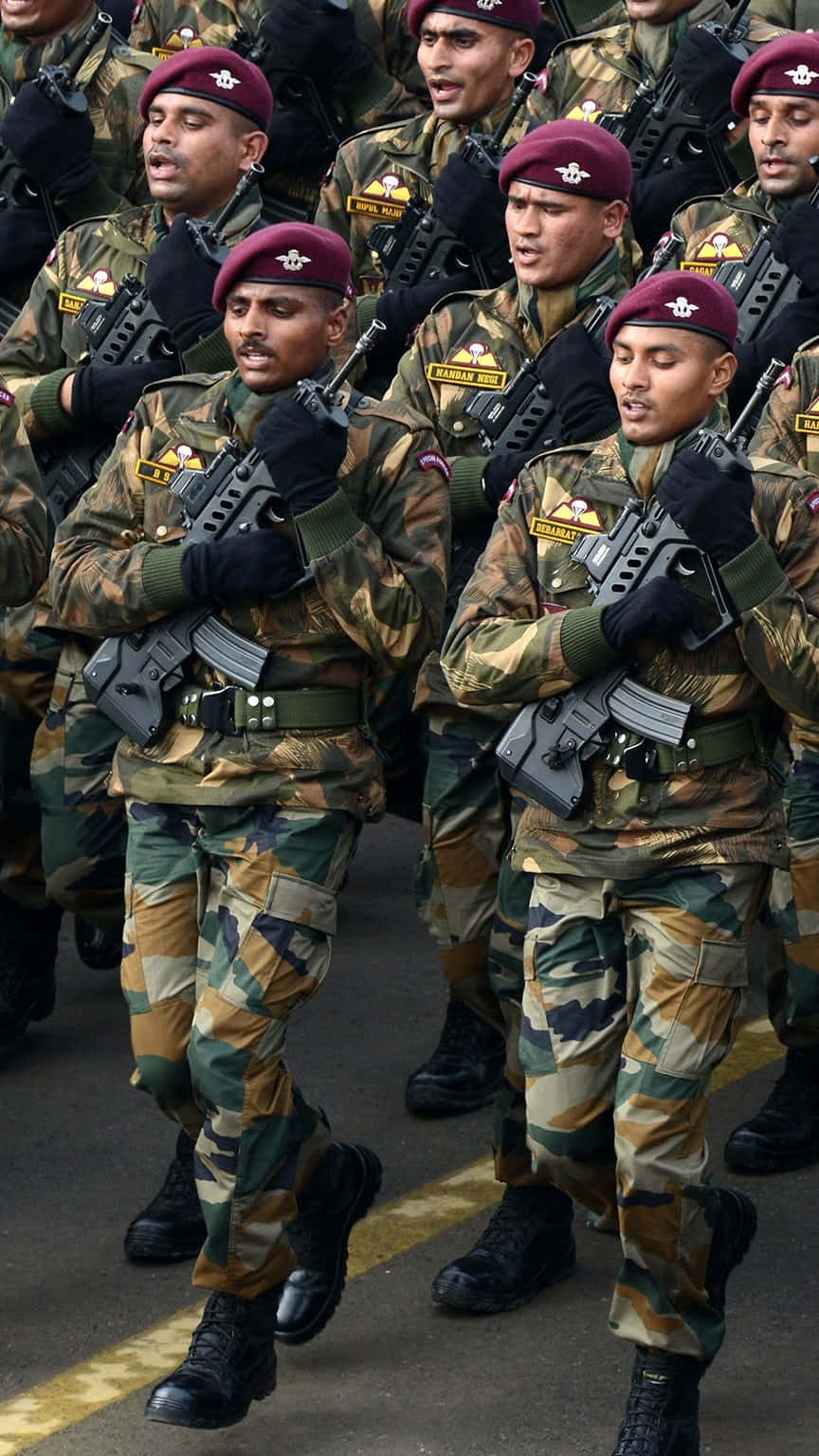 印度軍隊 桌布 壁紙 — 身穿迷彩制服和栗色貝雷帽的士兵在閱兵期間持步槍列隊行進。