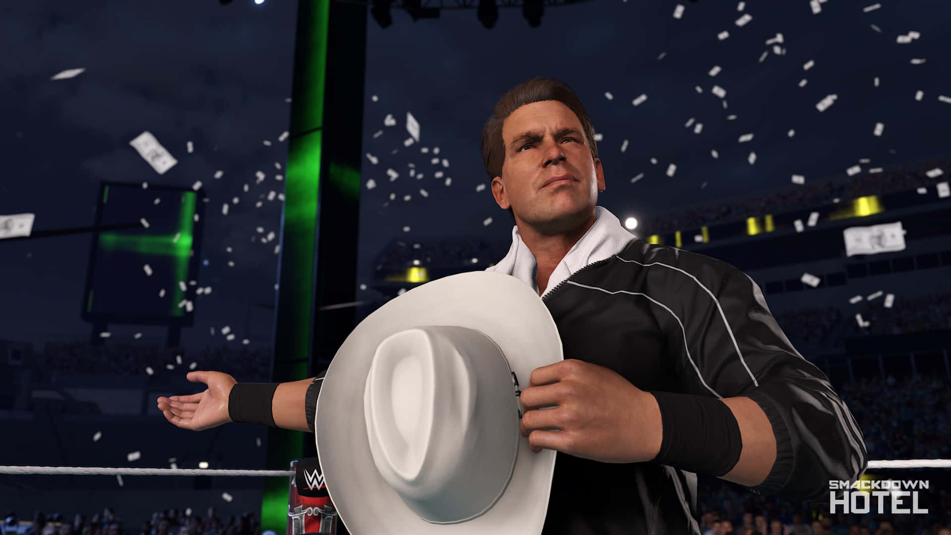 WWE 桌布 壁紙 — 身穿黑色外套的摔角手在夜晚燈光璀璨的競技場中，於飄落的五彩紙屑下手持白色牛仔帽。
