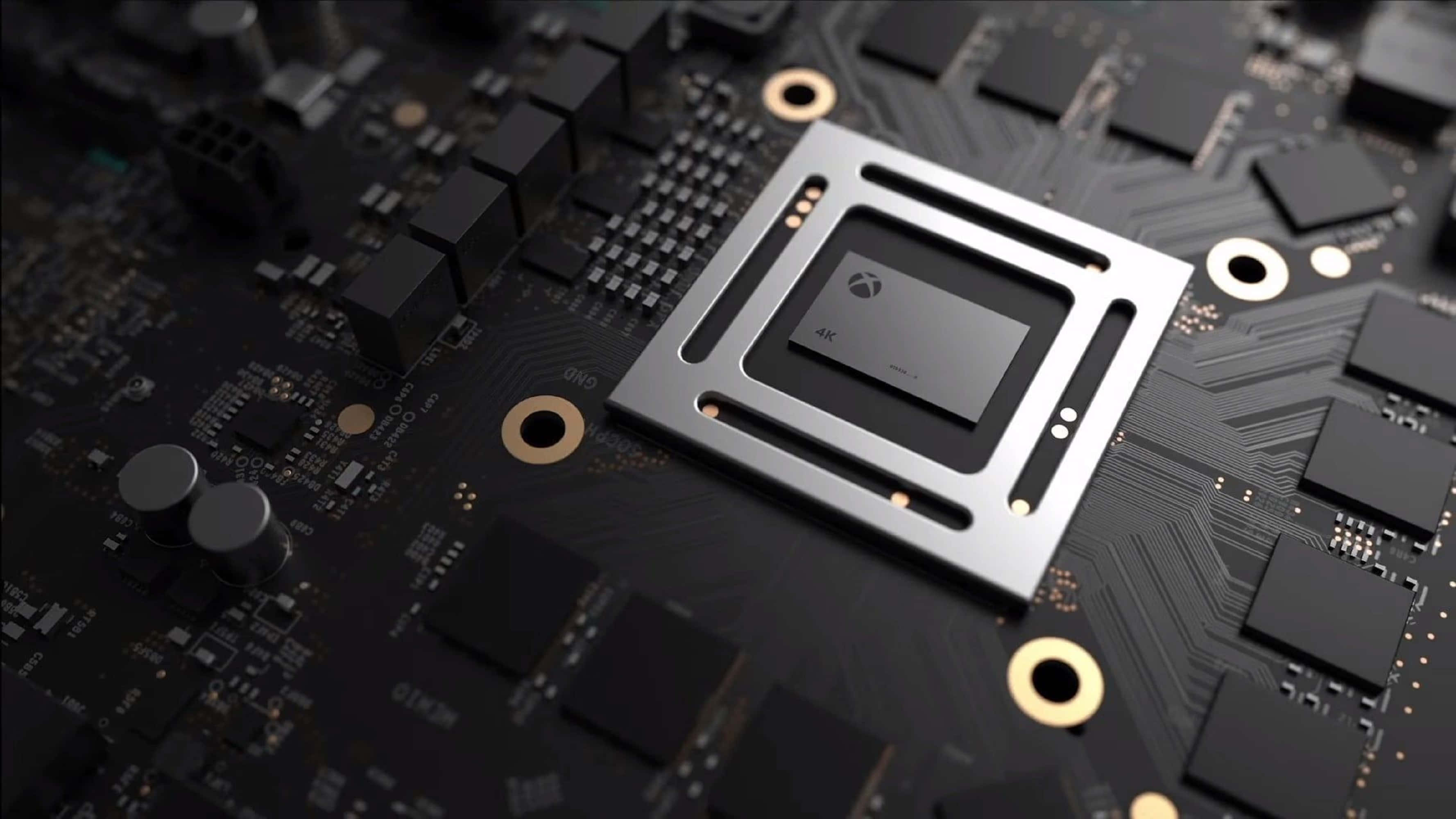 4K Processor 桌布 壁紙 — 近距離拍攝安裝在黑色電路板上的時尚Xbox GPU晶片，帶有複雜的金色和銀色線路。