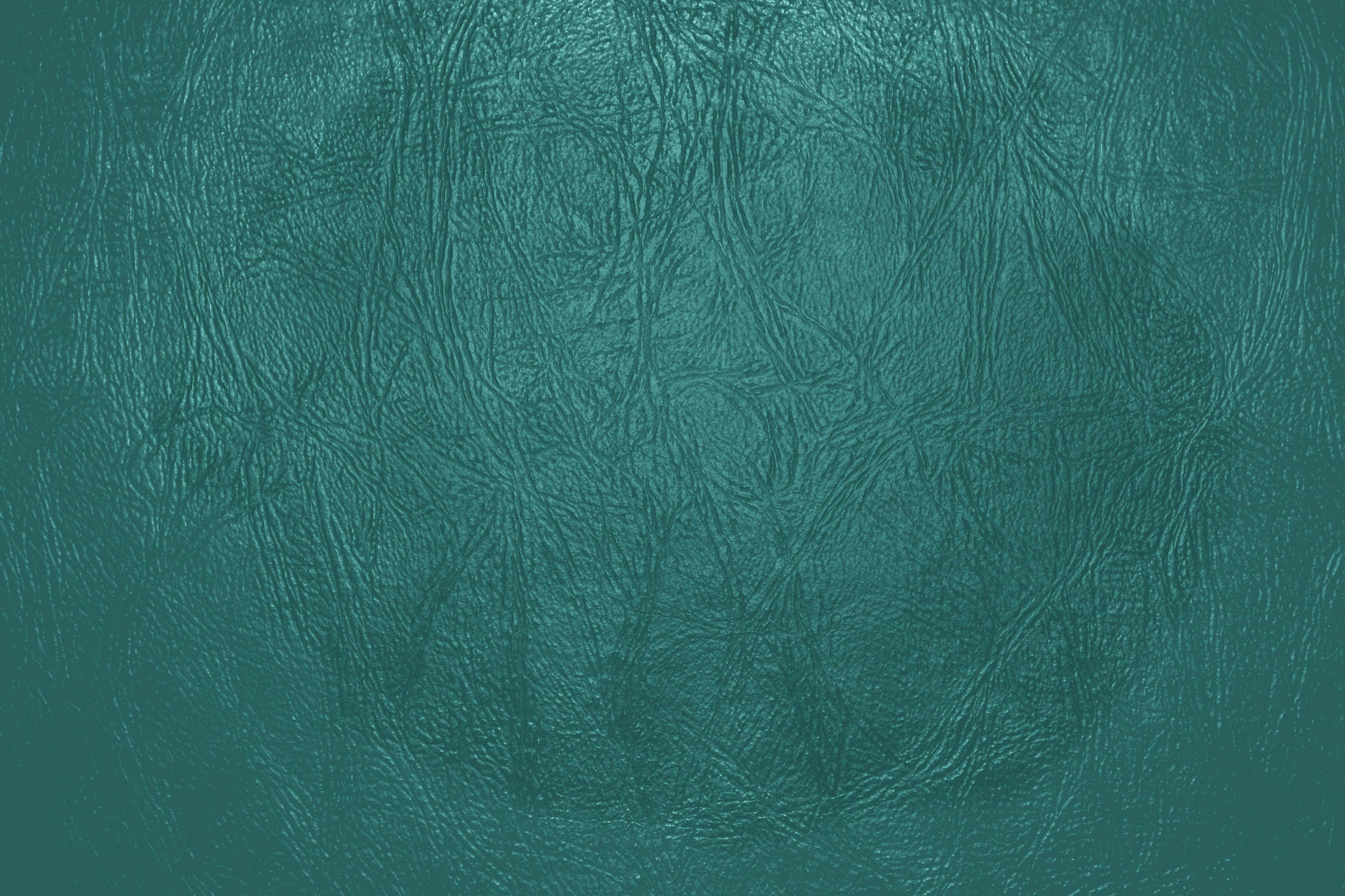 Dark Teal 桌布 壁紙 — 近距離拍攝帶有自然皺褶和柔和漸變燈光的紋理青綠色仿皮。