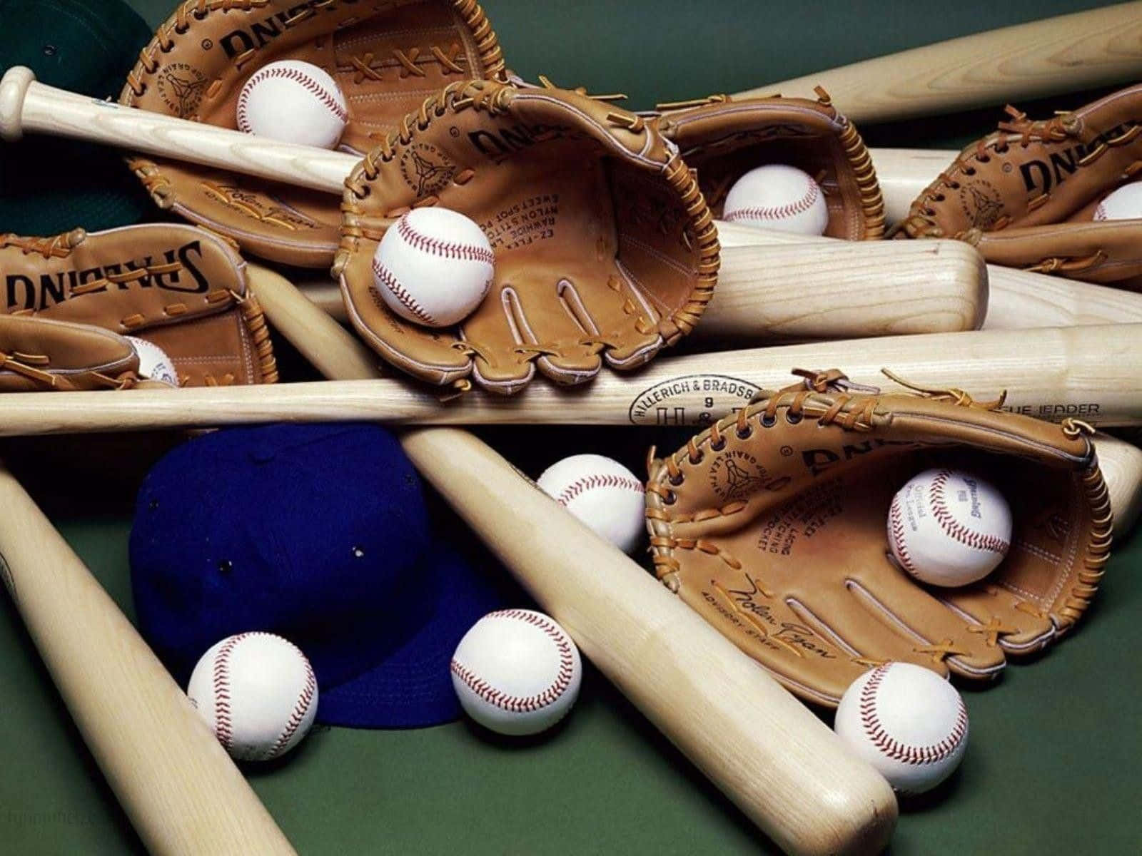 Baseball Gloves 桌布 壁紙 — 近距離拍攝棒球棍、手套和球排列在綠色表面上，配有一個藍色帽子。