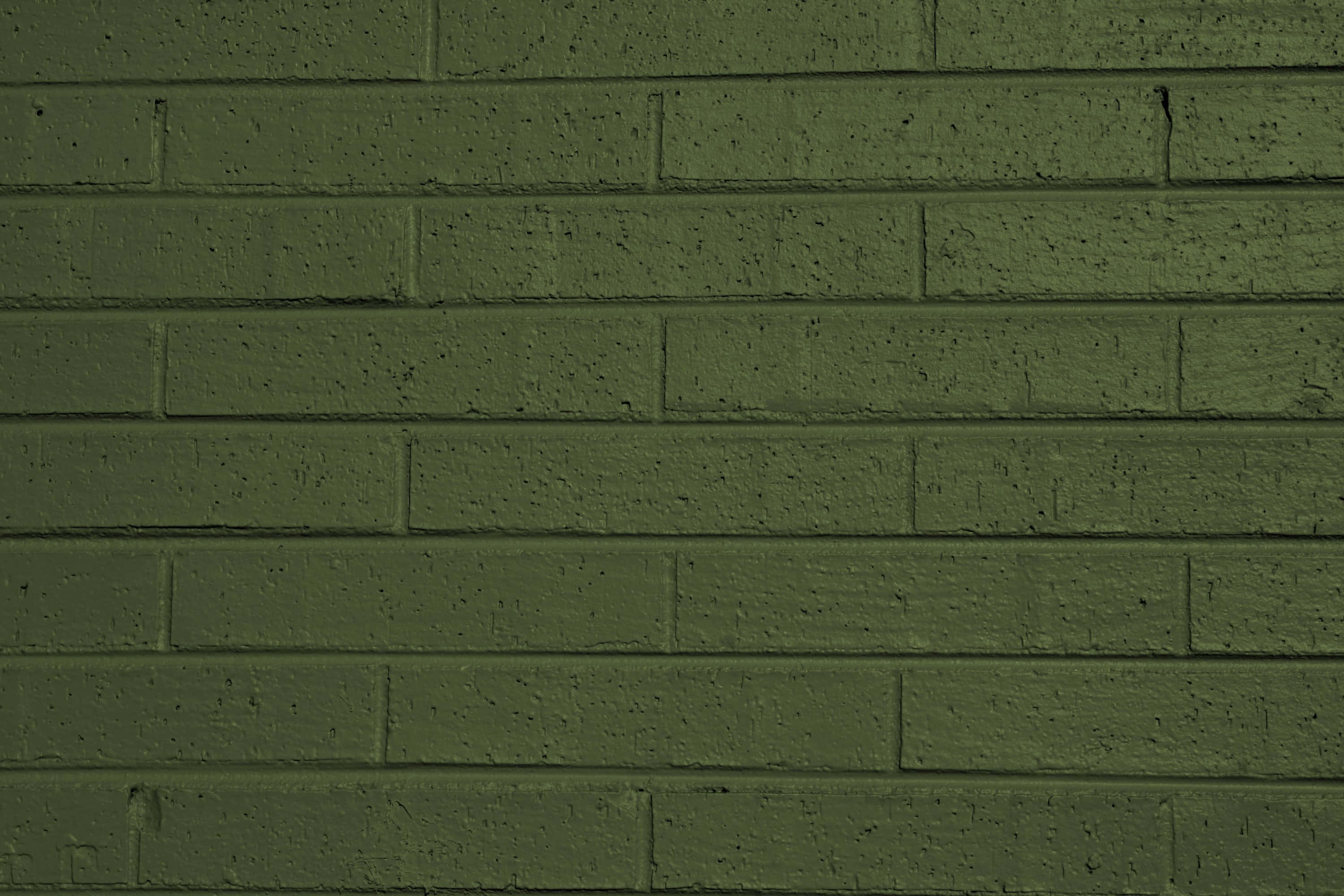 Brick Wall 桌布 壁紙 — 近距離拍攝的紋理橄欖綠磚牆，色調和砂漿線條有細微變化。