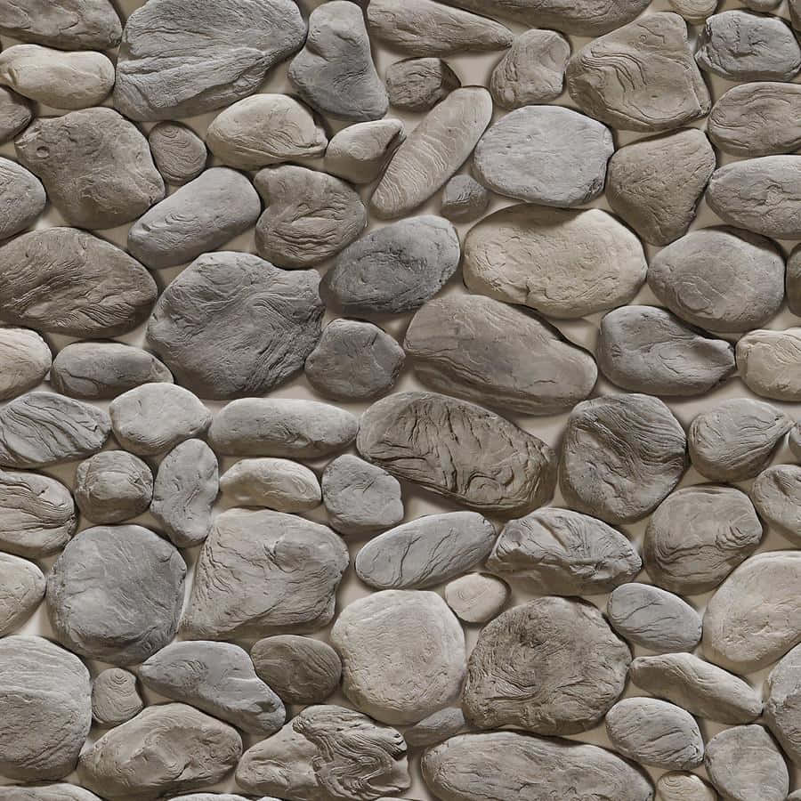 Stone 桌布 壁紙 — 近距離拍攝的紋理石牆，不規則形狀的灰色鵝卵石以自然馬賽克圖案排列。
