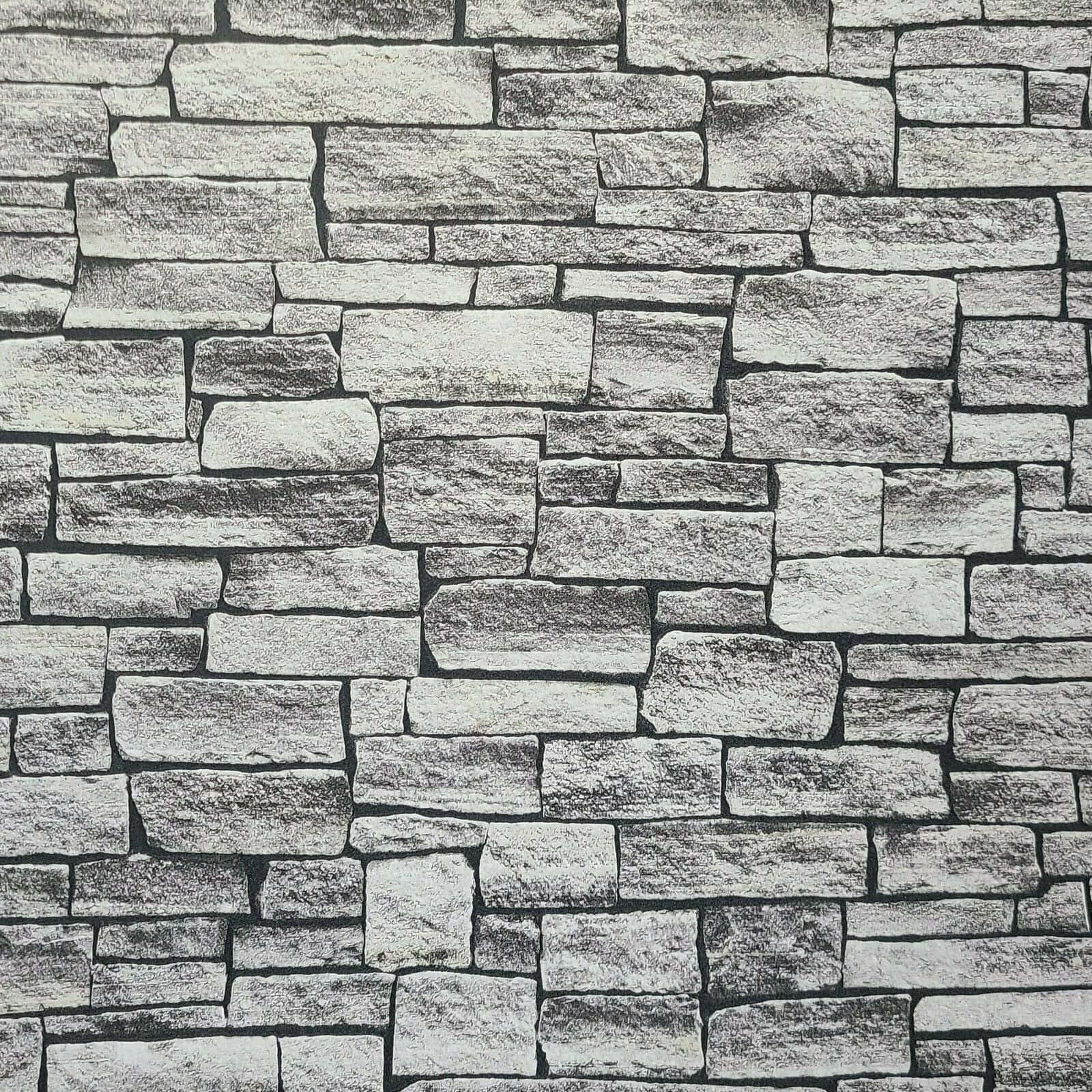 Brick Wall 桌布 壁紙 — 近距離拍攝的紋理石牆，不規則的灰色和白色塊狀排列成質樸的圖案。