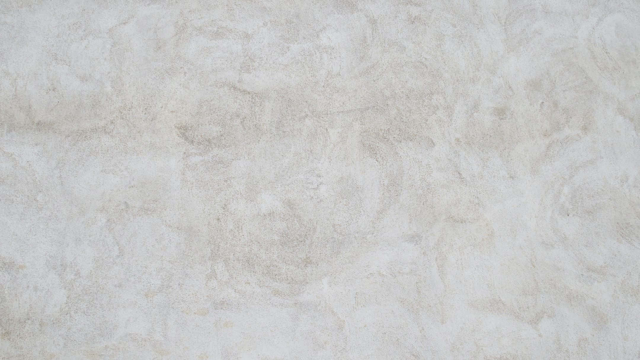 Wall Texture 桌布 壁紙 — 近距離拍攝的紋理米白色牆壁，帶有微妙的米色漩渦和柔軟不均勻的表面。
