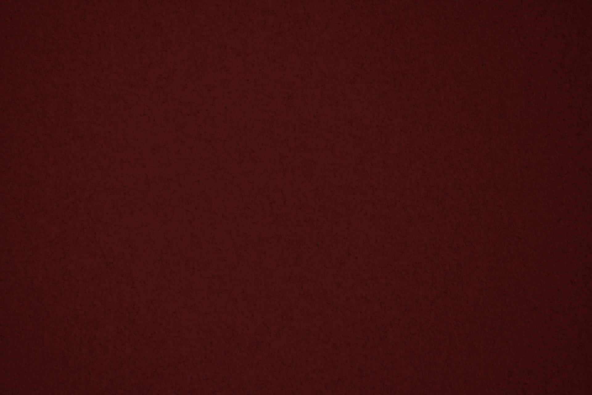 Maroon 桌布 壁紙 — 近距離拍攝的豐富酒紅色紋理表面，帶有細微斑點和柔和漸變燈光。